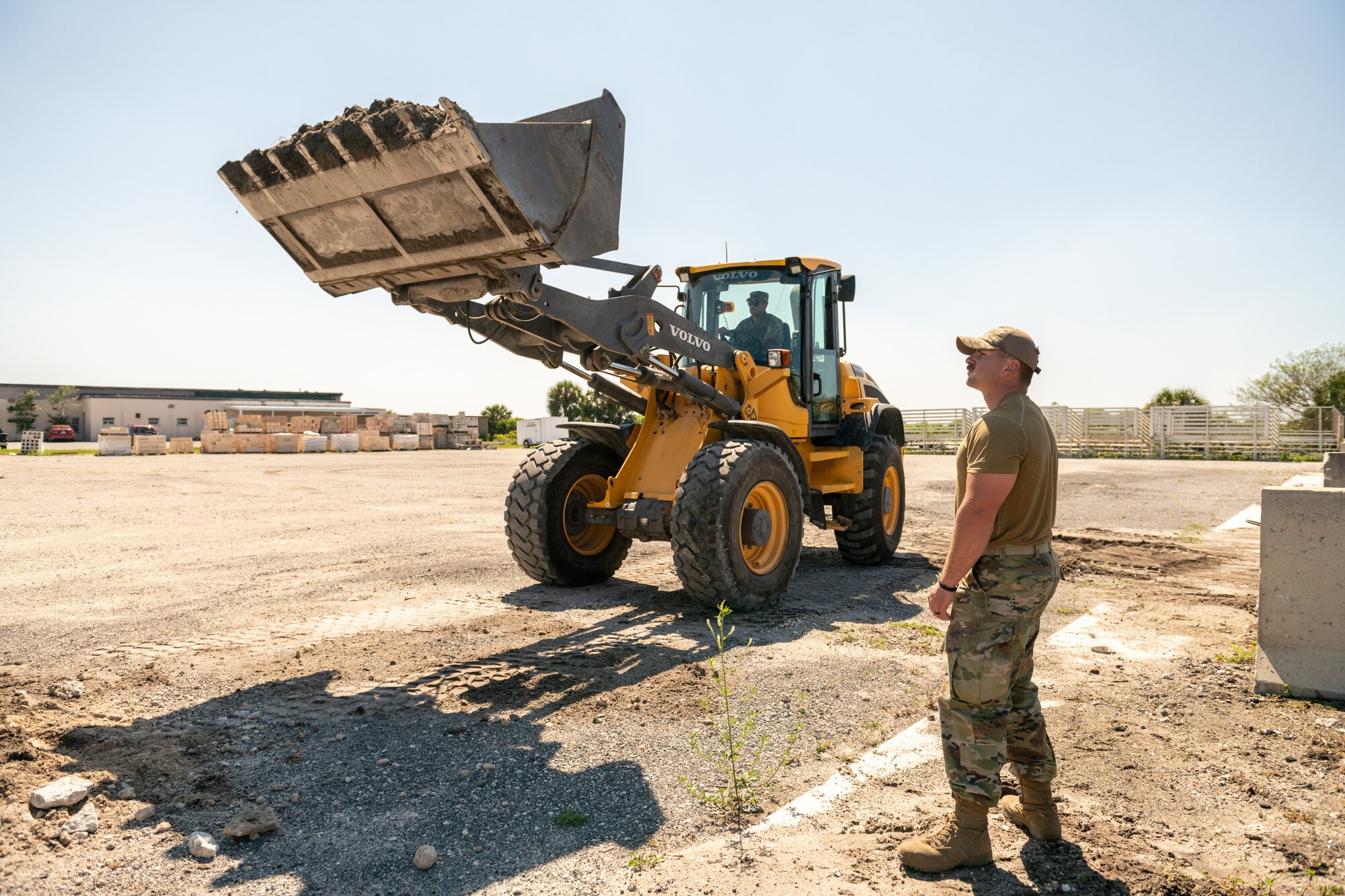 U.S. Air Force Senior Airman Christopher Brown, 45th Civil Engineer Squadron, monitors dirt loading operations during a training session March 17, 2022, at Patrick Space Force Base, Fla. Brown and several CE Airmen are preparing to compete in Readiness Challenge VIII at Tyndall Air Force Base, Fla., April 18-22. The competition will test their abilities to complete tasks associated with the CE career field. (U.S. Space Force photo by Josh Conti)