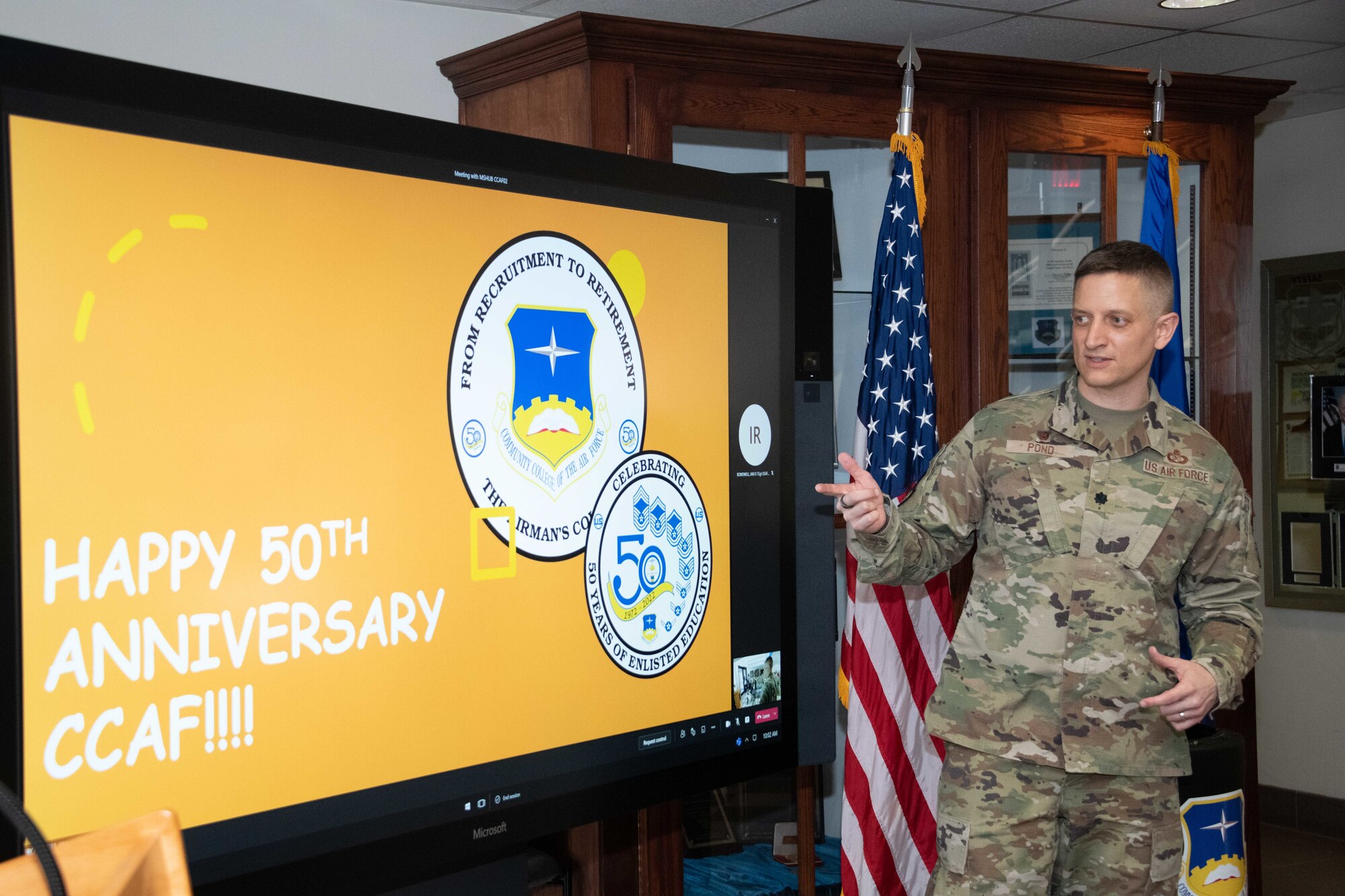 Lt. Col. Kevin Pond, Community College of the Air Force commandant, and staff members gather to open the CCAF time capsule in honor of its 50th anniversary, Apr. 1, 2022