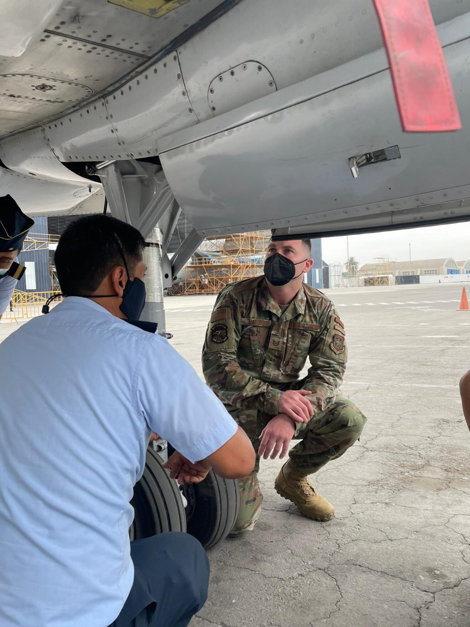 Tech. Sgt. Jacob Haines, 571st Mobility Support Advisory Squadron air advisor, discusses an aircraft’s hydraulic system with Peruvian Air Force members March 1, 2022, at Callao Air Base, Lima, Peru. PERAF members were guided through an interactive discussion on the KC-130, PERAF’s most used aircraft to conduct personnel and cargo transport, air evacuation, and humanitarian aid and disaster relief missions. (Courtesy photo)