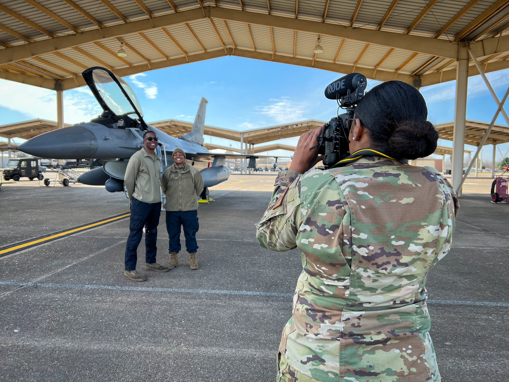 Staff Sgt. Nije Hightower, 301st Fighter Wing Public Affairs Specialist, takes a photo of two crew chiefs at Barksdale Air Force Base, Louisiana on March 9, 2022. Hightower participated in joint public affairs training that involved logistics, such as coordination of collecting imagery or footage for a project and ensuring proper safety practices on the flightline are followed.