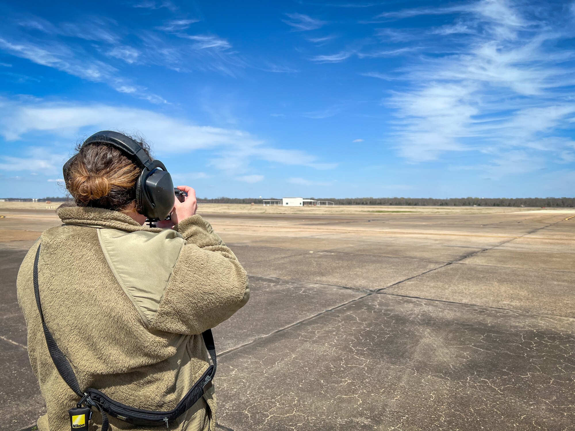 Staff. Sgt. Tambri Cason, 307th Bomb Wing Public Affairs Specialist, shoots video on the flightline as at Barksdale Air Force Base, Louisiana on March 9, 2022. Cason participated in joint public affairs training that involved logistics, such as coordination of collecting imagery or footage for a a project and ensuring proper safety practices on the flightline are followed.