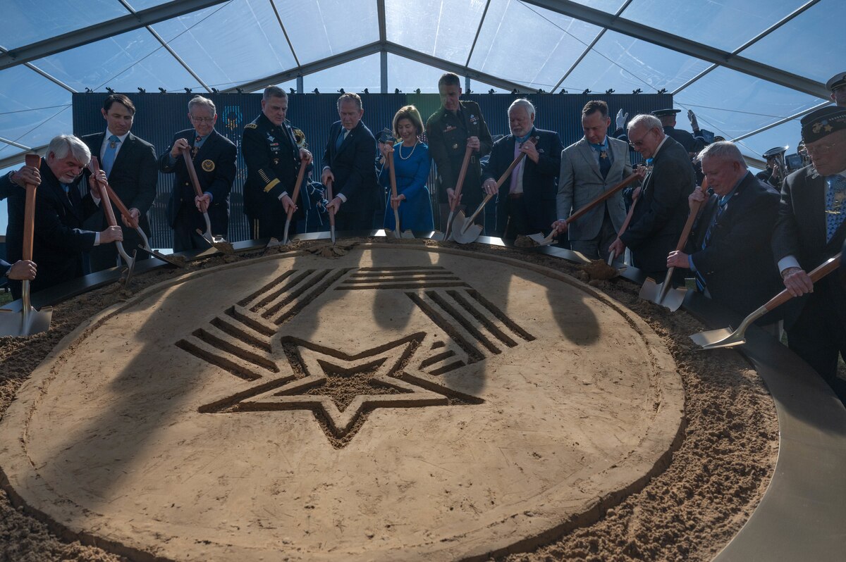 Former U.S. President George W. Bush, wife Laura Bush, 20th Chairman of the Joint Chiefs of Staff Gen. Mark A. Milley, Vice Chief of Staff of the Army Gen. Joseph M. Martin, 15 Medal of Honor recipients and other distinguished visitors dig into the sand display as a part of the ground breaking ceremony of the National Medal of Honor Museum, March 25, 2022 at Arlington, Texas. The museum will serve as the only national institution dedicated to the livelihood and legacy of the service members who have and will become Medal of Honor recipients. (U.S. Air Force photo by Senior Airman Tyler McQuiston)