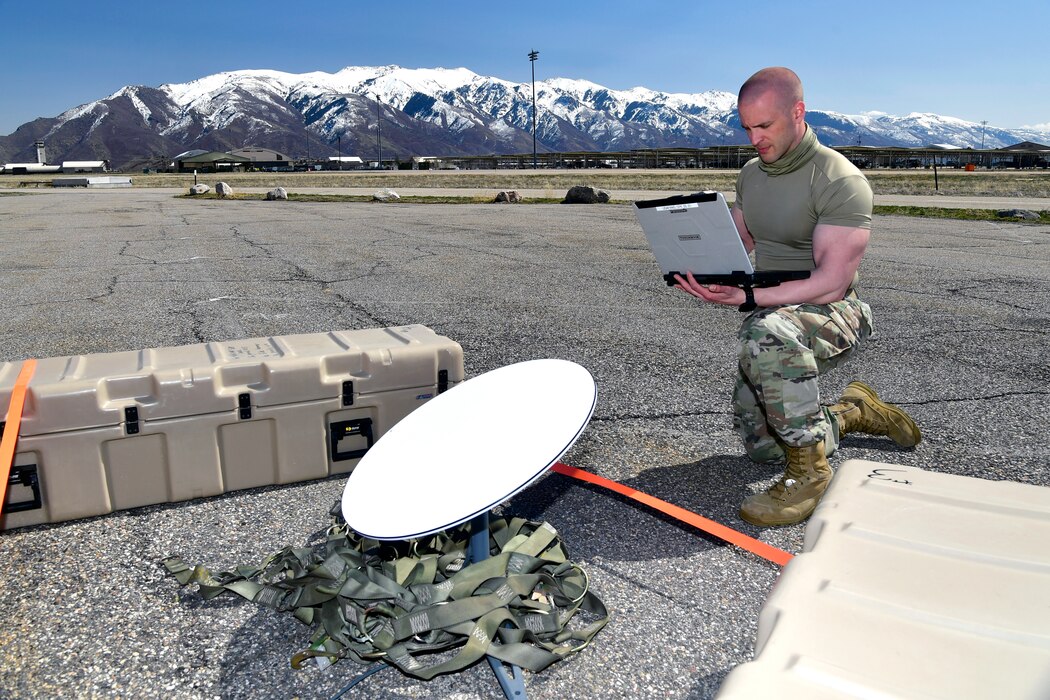 Master Sgt. Caleb Frisbie, 242nd Combat Communications Squadron, sets up and tests communication equipment