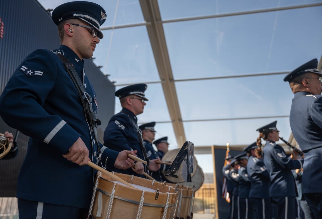 U.S. Air Force Airman 1st Class Austin Pierce, Band of the West percussionist, plays the drums during the National Medal of Honor Museum ceremony, March 25, 2022 at Arlington, Texas. The Band of the West in partnership with the Air National Guard Band of the Southwest, members from the Band of Mid America, and USAF Heritage of America band are unified to create the USAF Total Force Band to be part of this groundbreaking ceremony. (U.S. Air Force photo by Senior Airman Tyler McQuiston)