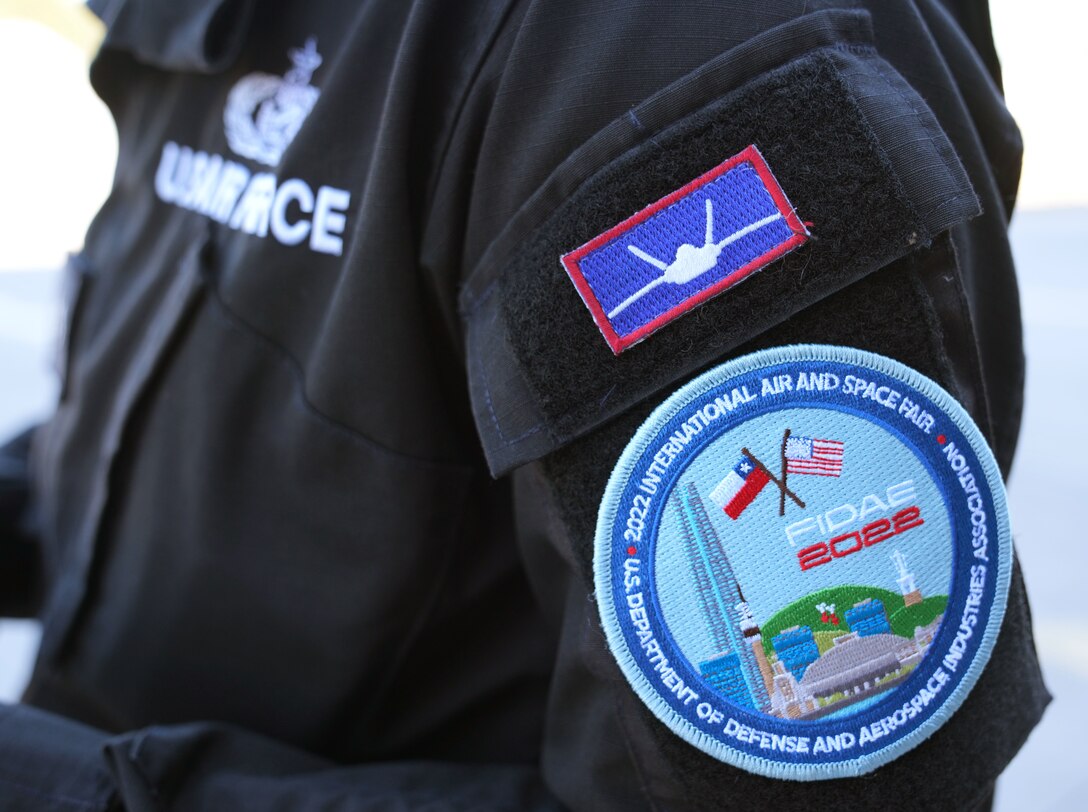 A member of the F-22 Raptor Demonstration Team displays his FIDAE 2022 Patch at Latin America’s Largest aerospace, defense and security exhibition in Santiago, Chile, April 5, 2022.