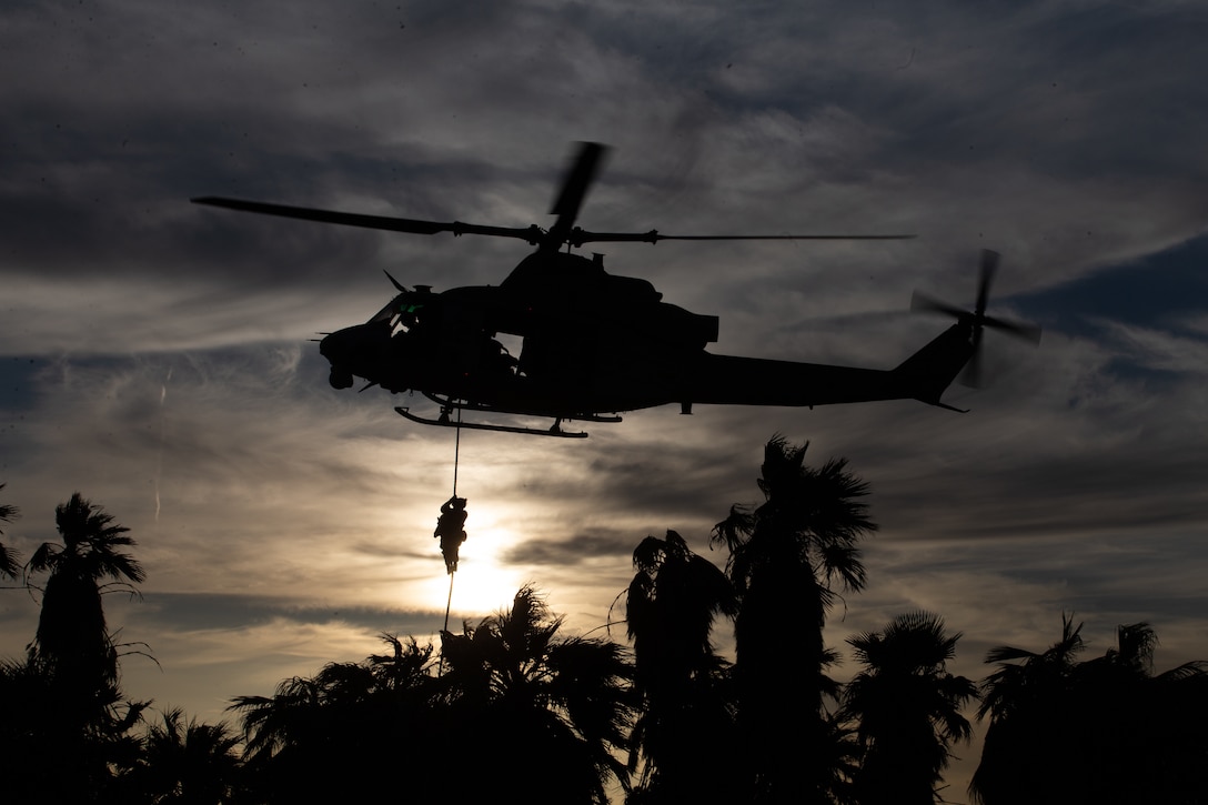 U.S. Marines with 1st Battalion, 2nd Marine Regiment, 2nd Marine Division, conduct fast rope insertion drills, during Weapons and Tactics Instructor course 2-22, at K-9 Village, Yuma Proving Grounds, Arizona, April 2, 2022. WTI is a seven-week training event hosted by Marine Aviation Weapons and Tactics Squadron One, providing standardized advanced tactical training and certification of unit instructor qualifications to support Marine aviation training and readiness, and assist in developing and employing aviation weapons and tactics.