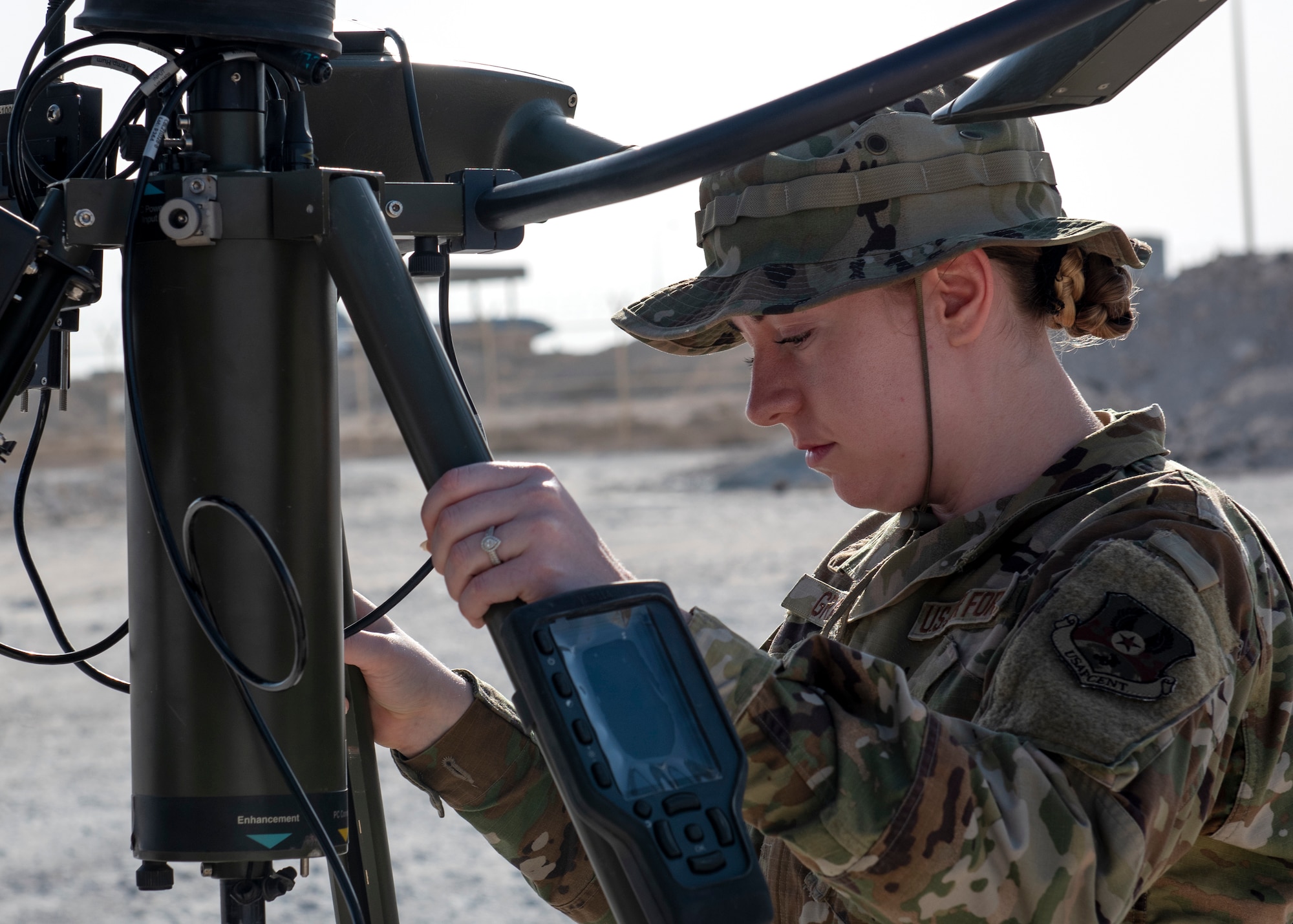 photo of an airman setting up weather reading equipment
