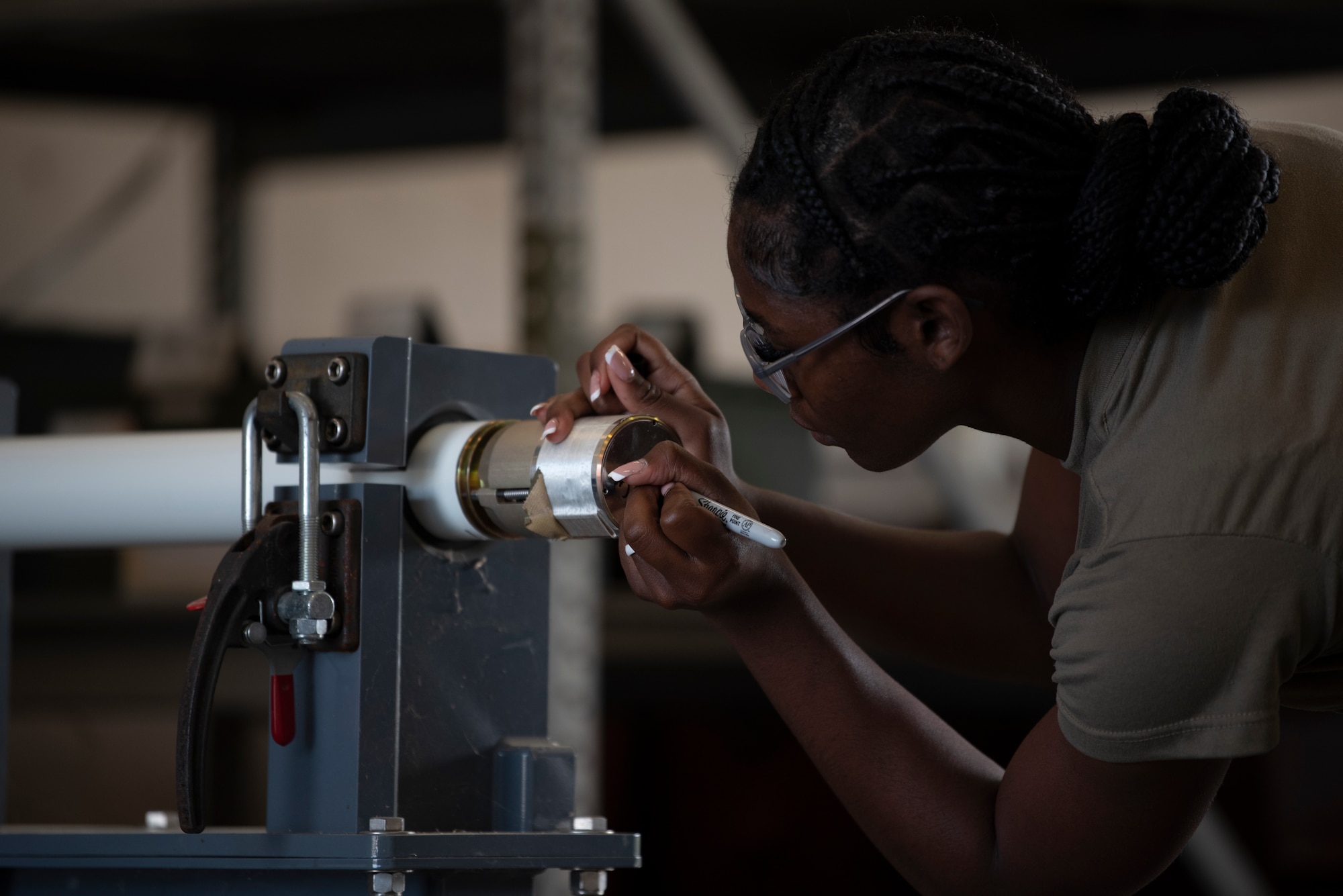 A photo of a person writing numbers on the end of a rocket.