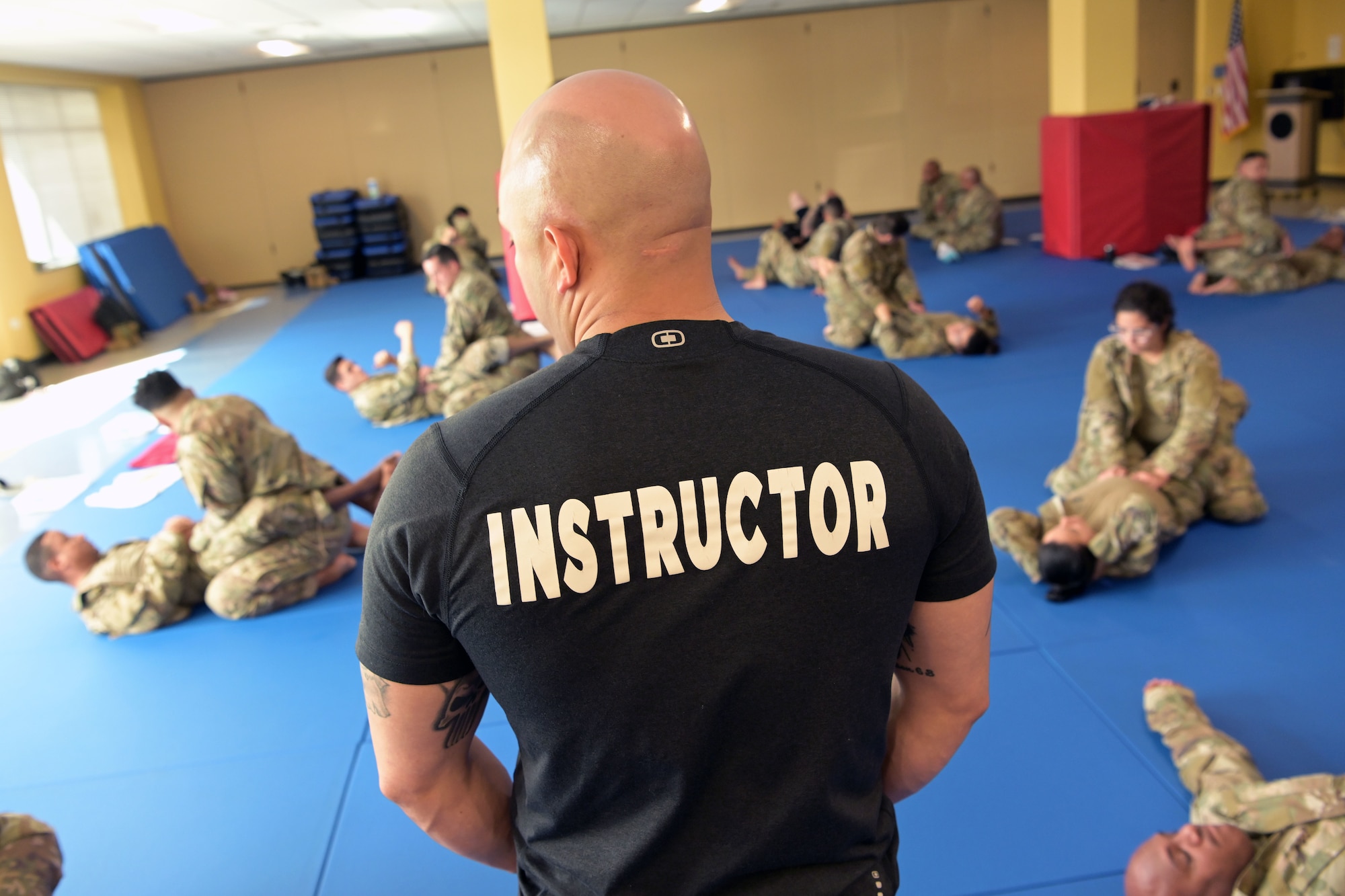 U.S. Air Force Master Sgt. Brian Cantu, an Air Force senior combatives instructor, with the 621st Contingency Response Squadron, Joint Base Mcguire-Dix-Lakehurst, oversees Airmen practice grappling techniques, March 16, 2022 at Muñiz Air National Guard Base, Puerto Rico. The 22 newly graduated Air Force Combatives instructors, all from different sections of the 156th Wing can pass down the knowledge they’ve acquired to other Airmen and assist in developing an always ready fighting force. “For us as instructors, just being able to see the Airmen grow in the aspect of having a mentality of ‘You know what? Size doesn't matter, as long as I use proper technique’ we’re good to go,” said Cantu. (U.S. Air National Guard photo by Master Sgt. Rafael D. Rosa)