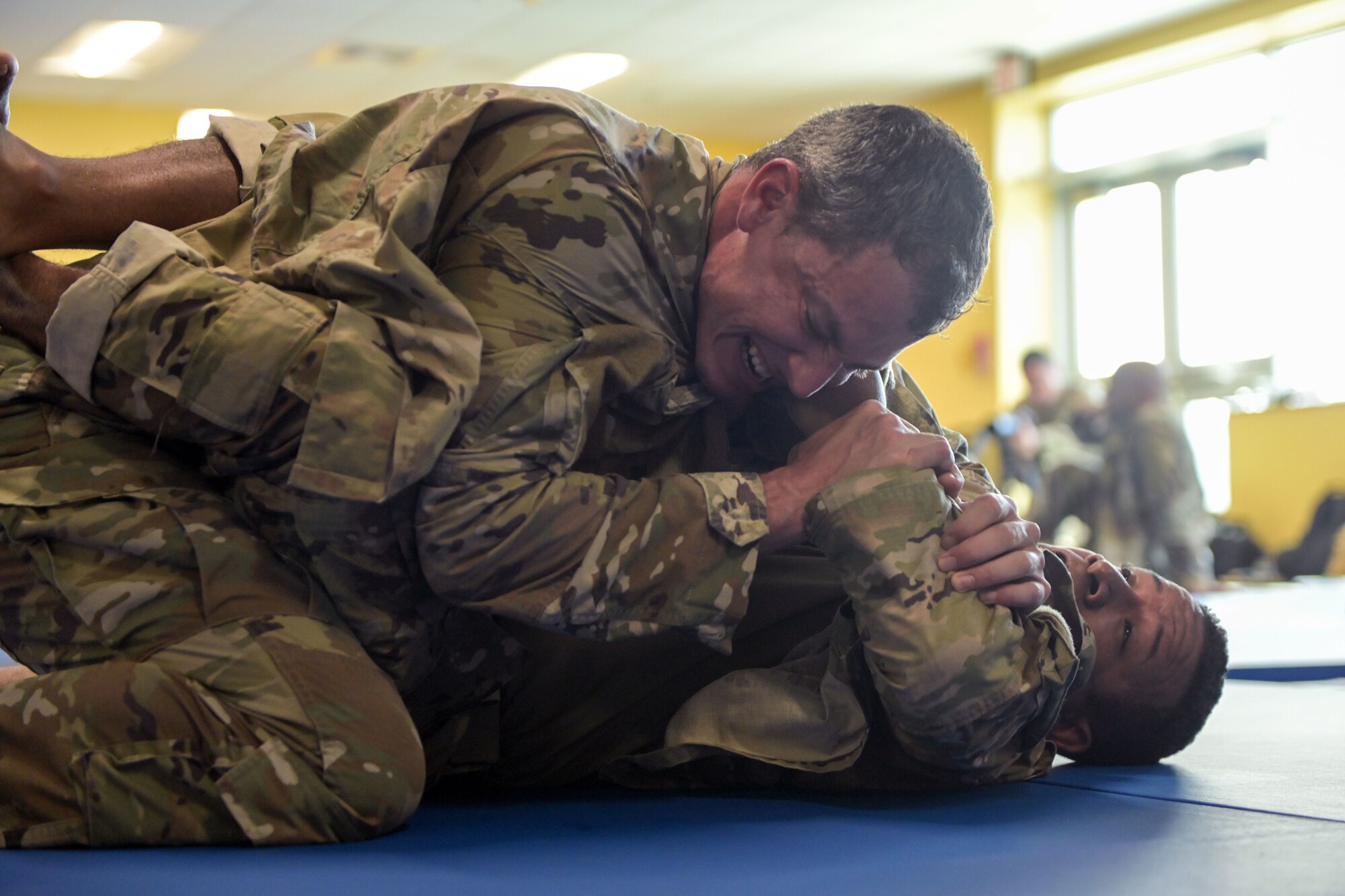 U.S. Air Force Tech. Sgt. Jose Rodriguez, a radio frequency transmissions systems journeyman, with the 156th Combat Communications Squadron, tries to escape the guard position from Staff Sgt. Irvin Morales, a Security Forces craftsman, with the 156th Security Forces Squadron, March 17, 2022 at Muñiz Air National Guard Base, Puerto Rico. The 22 Airmen that graduated the Air Force Combatives Program learned the basics of becoming a combatives instructor and will augment the 156th Wing’s fighting force by having the capability to train other Airmen. (U.S. Air National Guard photo by Master Sgt. Rafael D. Rosa)