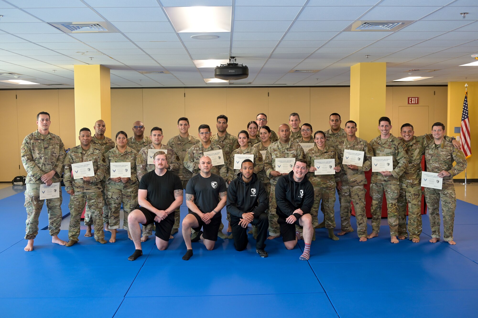 U.S. Airmen with the 156th Contingency Response Group, 156th Combat Communications Squadron and the 156th Security Forces Squadron, receive certificates for completing the Air Force Combatives Program, March 18, 2022 at Muñiz Air National Guard Base, Puerto Rico. The 22 Airmen that graduated the Air Force Program learned the basics of becoming a combatives instructor through three separate modules, the standing module, ground module and the Air Force combatives history module. (U.S. Air National Guard photo by Staff Sgt. Eliezer Soto)