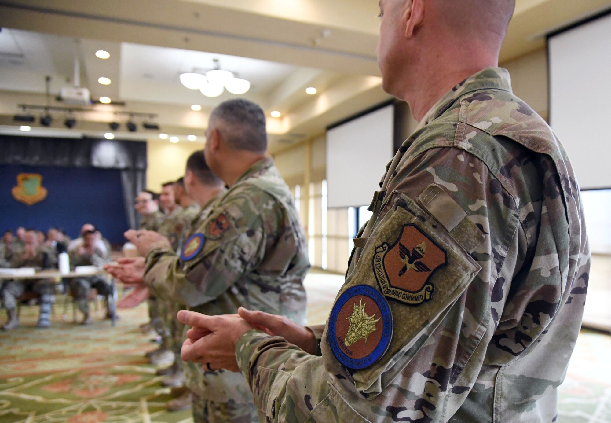 Keesler's first Dragon University Airmen are recognized during a ceremony inside the Bay Breeze Event Center at Keesler Air Force Base, Mississippi, April 6, 2022. Dragon University is the 81st Training Wing's Professional Development Incentive Program. The program is led by the Keesler Air Force Base career assistance advisor, and is supported by the Total Force Development Council, Chief's Group, Company Grade Officer Council, Top III and the 5/6. After completing the program, each Airman will receive a patch for military members and a pin for civilians. (U.S. Air Force photo by Kemberly Groue)