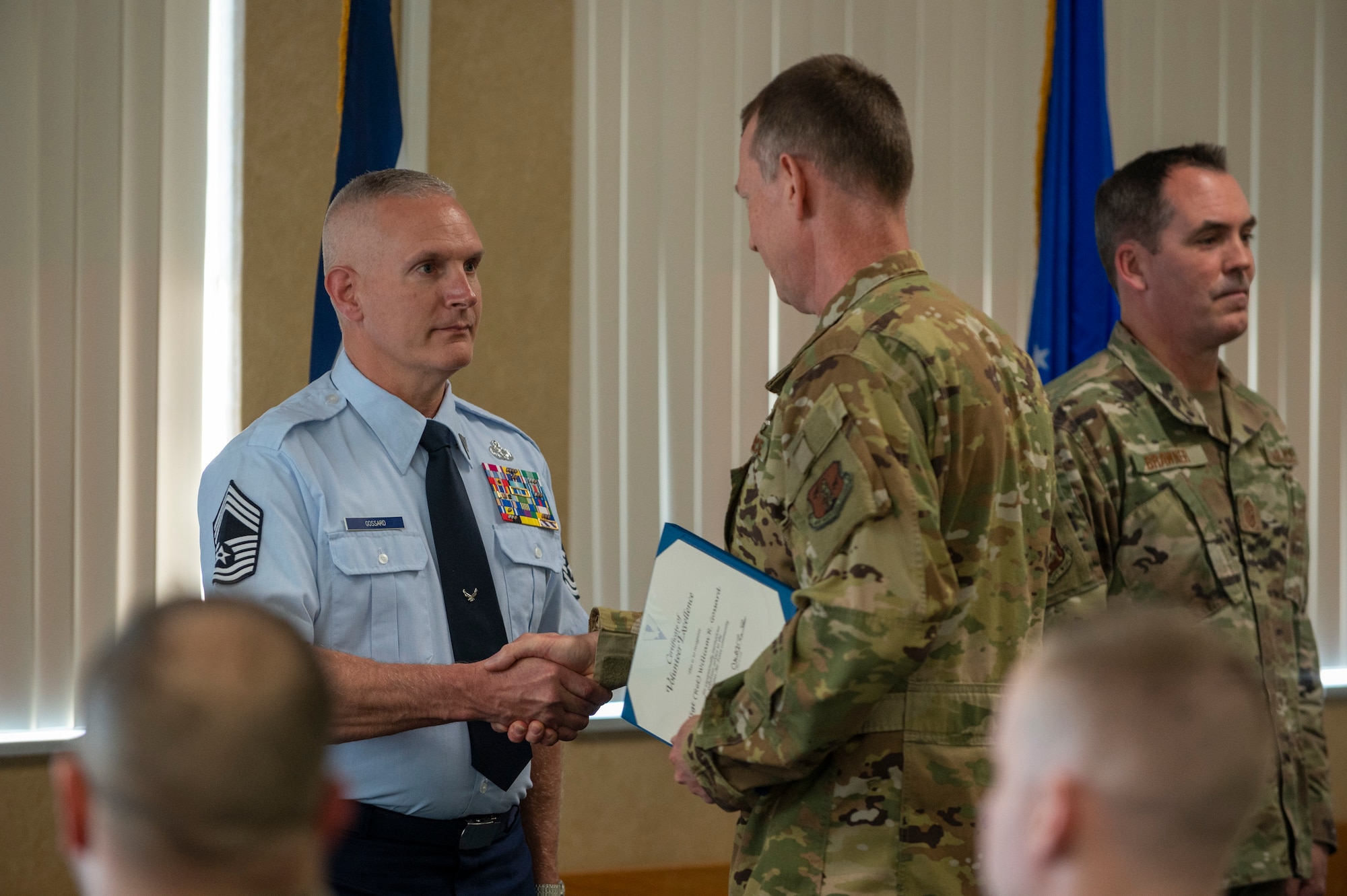 Retired U.S. Air Force Chief Master Sgt. Robert Gossard is awarded the Volunteer of The Year award by Col. Christopher Sigler, acting 167th Airlift Wing commander,  during the Outstanding Airmen of the Year  ceremony at the the 167th base dining facility, Martinsburg, West Virginia, Apr. 2, 2022. The award was presented to him for selflessly contributing more than 400 work hours in 2021 through leading and mentoring the 167th student flight