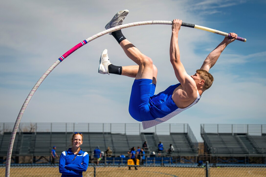 An Air Force cadet competes in a pole vault competition.