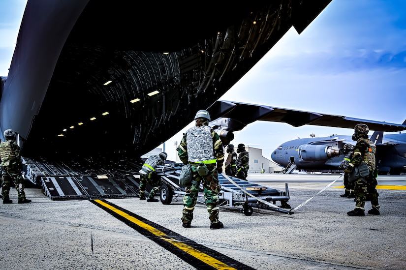 U.S. Air Force Airmen from the 305th Air Mobility Wing wearing mission oriented protective posture gear prepare to upload maintenance equipment onto a C-17 Globemaster III, demonstrating the ability to survive and operate in a contested environment during a readiness exercise at Joint Base McGuire-Dix-Lakehurst, New Jersey, Apr. 4, 2022. Training exercises reinforce Airmen readiness and deliberately strengthen Air Mobility Command’s warfighting culture in order to provide unrivaled Rapid Global Mobility capable of protecting and sustaining the Joint Force.