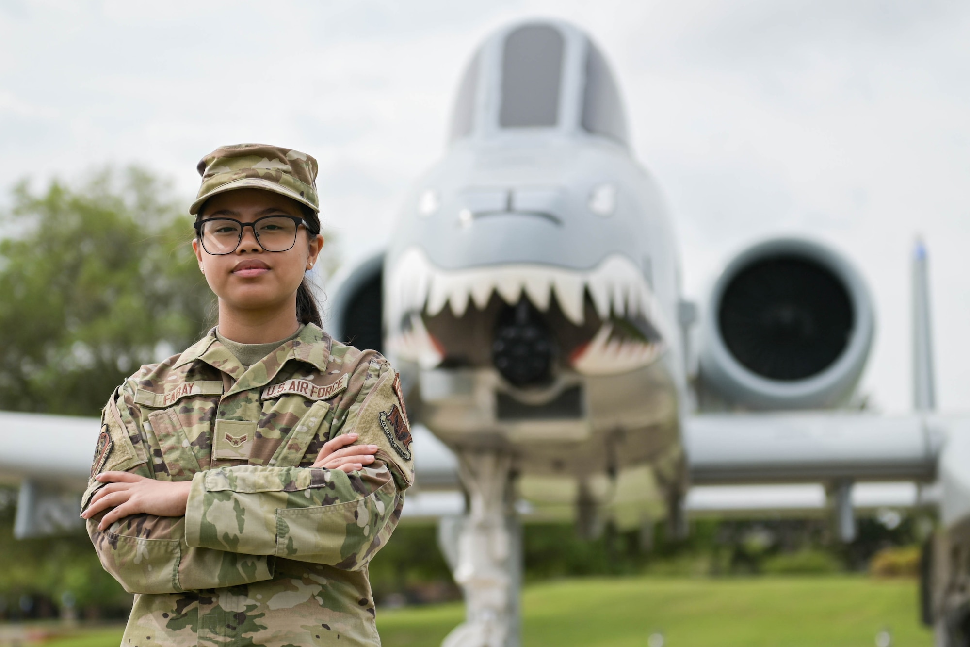 U.S. Air Force Airman 1st Class Jan Beatrice Fabay, 23rd Force Support Squadron career development assignments technician, poses in front of an A-10C Thunderbolt II aircraft, April 5, 2022, at Moody Air Force Base, Georgia. The assignments section has to carefully vet all assignments and provide correct information to affected Airmen. (U.S. Air Force photo by Senior Airman Rebeckah Medeiros)