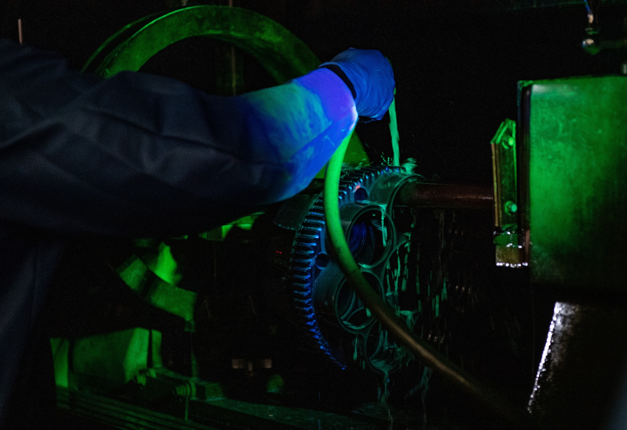 U.S. Air Force Airman 1st Class Jamorris Lewis, a 23rd Maintenance Squadron nondestructive inspection apprentice, accomplishes a magnetic particle inspection on an A-10 Thunderbolt II GAU-8 weapons system part at Moody Air Force Base, Georgia, April 5, 2022. The fluorescent dye penetrant glows under blacklight, which can show minute imperfections in the system that over time would lead to a part failure. (U.S. Air Force photo by Staff Sgt. Melanie A. Bulow-Gonterman)