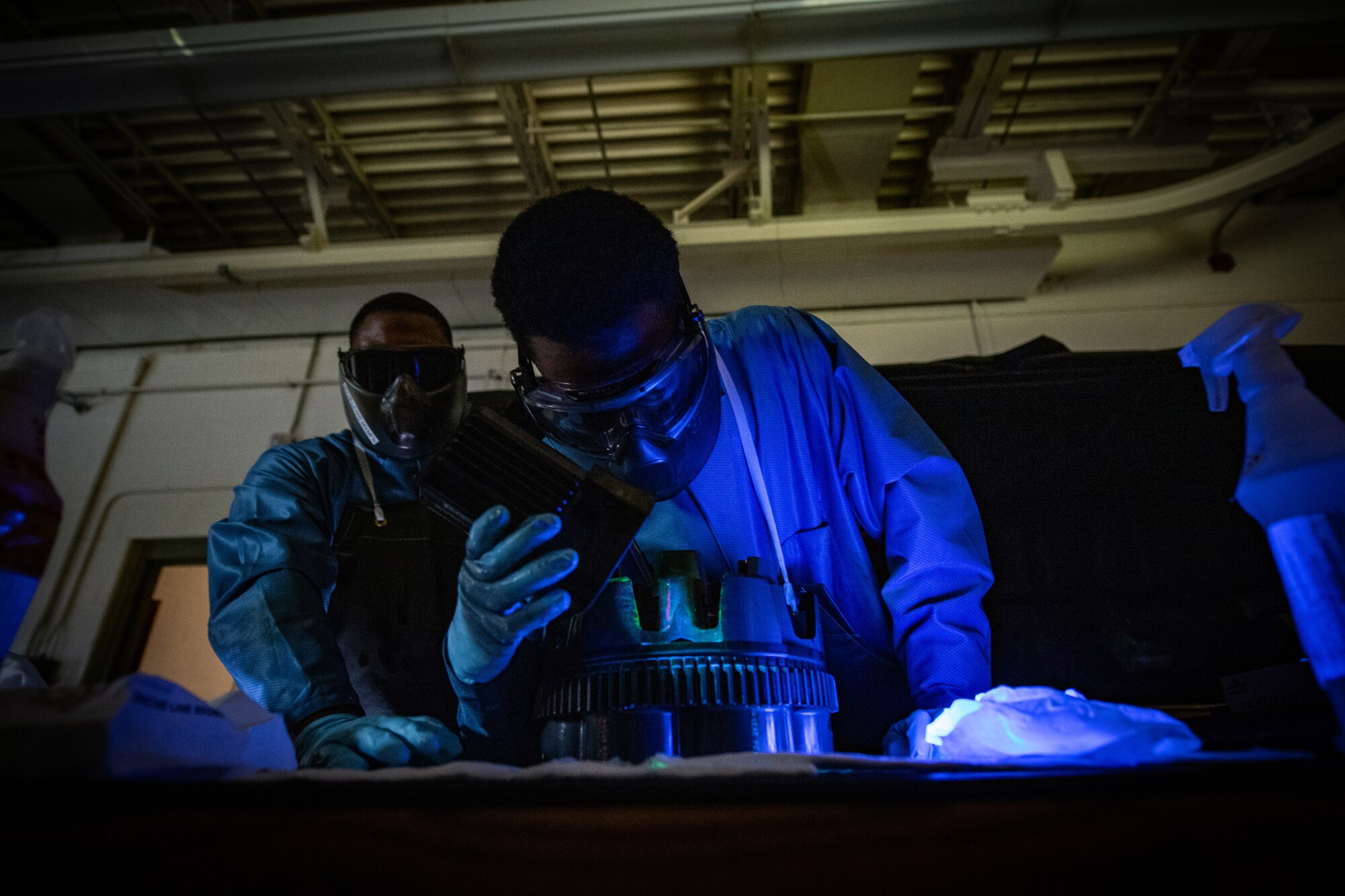 U.S. Air Force Airman Roderick Dennis, a 23rd Maintenance Squadron nondestructive inspection apprentice, inspect an A-10 Thunderbolt II GAU-8 weapons system with a blacklight for cracks and structural integrity during a magnetic particle inspection at Moody Air Force Base, Georgia, April 5, 2022. Various types of dyes and florescent lighting are used to uncover discrepancies that are unable to be seen by the naked eye. (U.S. Air Force photo by Staff Sgt. Melanie A. Bulow-Gonterman)