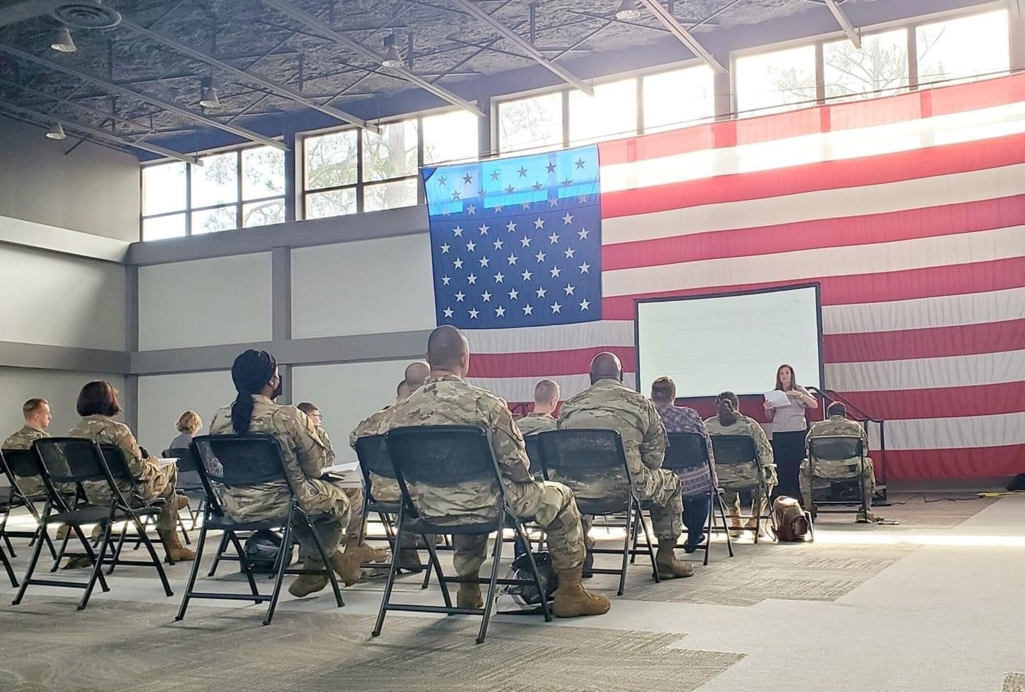 people sitting in a room with an American flag