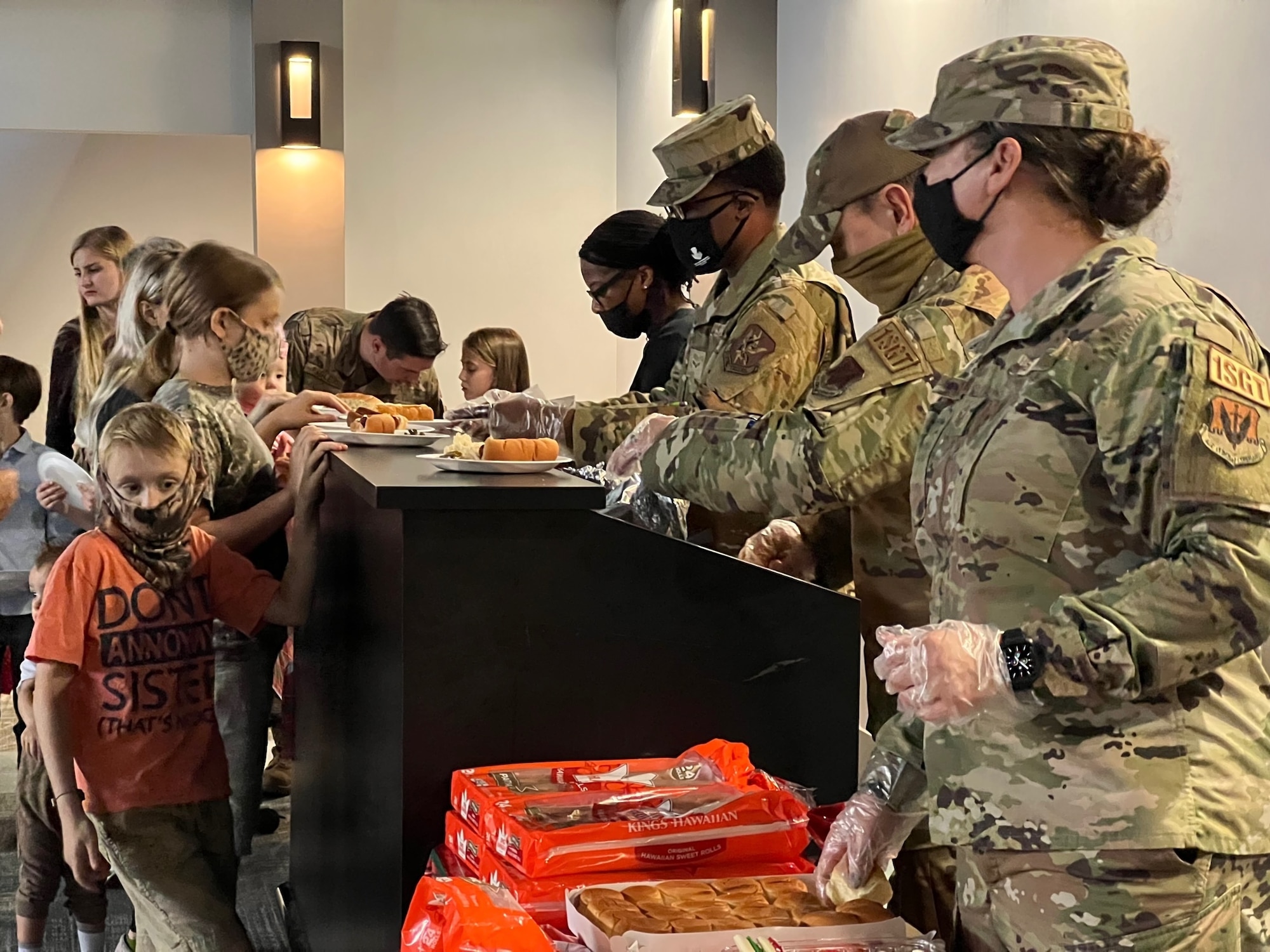 people in uniform serving food