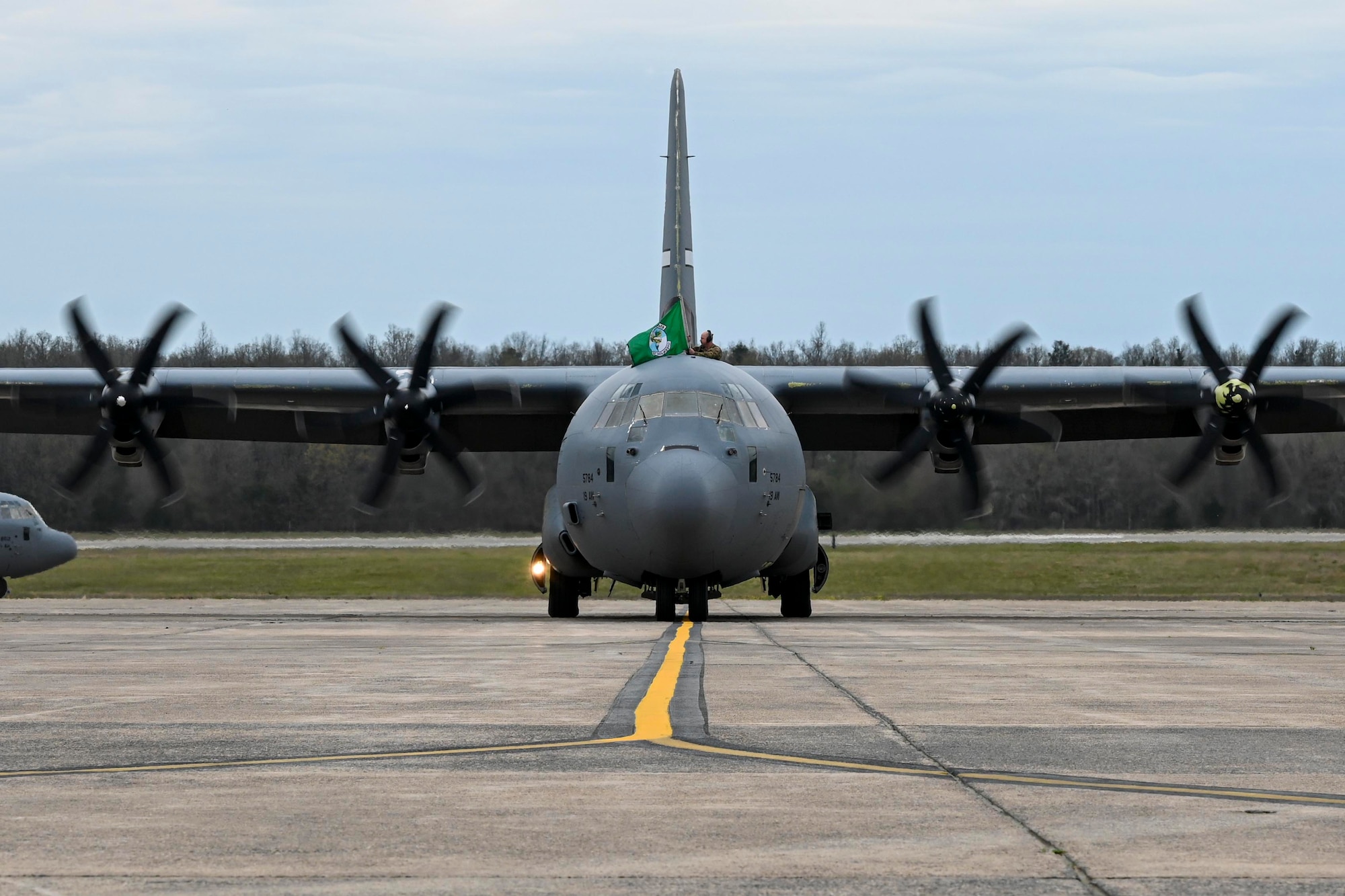 A C-130J Super Hercules taxis on the flightline at Little Rock Air Force Base, Arkansas, as Airmen from the 19th Airlift Wing return from a deployment