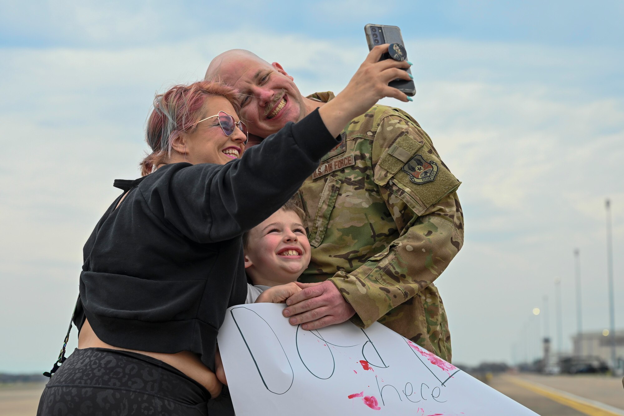 An Airman from the 19th Airlift Wing reunites with his family at Little Rock Air Force Base, Arkansas, after returning from a deployment