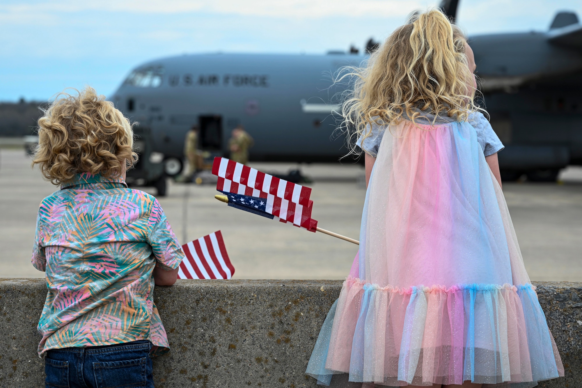 Family members wait for the return of deployed Airmen from the 19th Airlift Wing