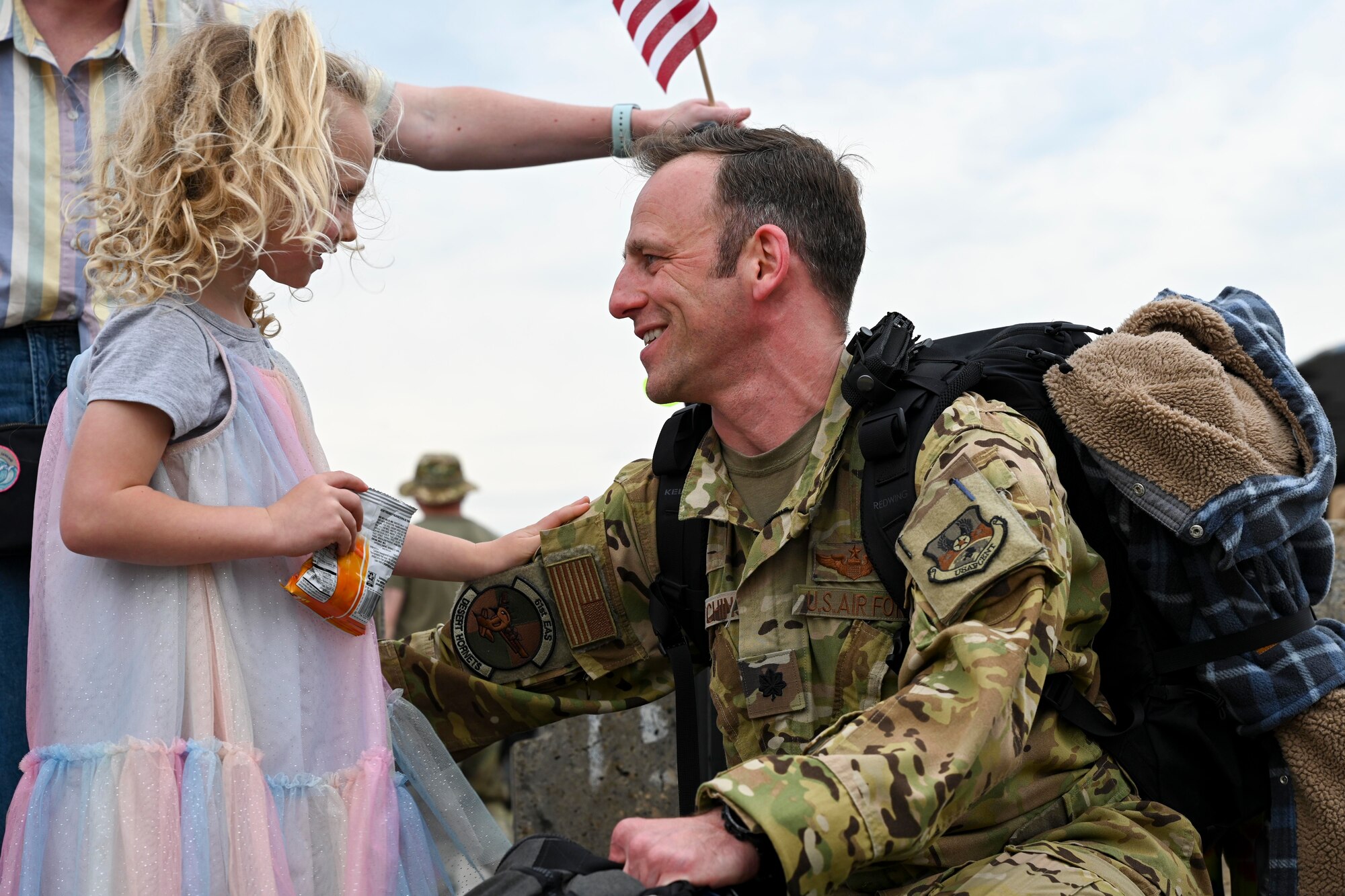 An Airman from the 61st Airlift Squadron reunites with his daughter at Little Rock Air Force Base, Arkansas, after returning from a deployment
