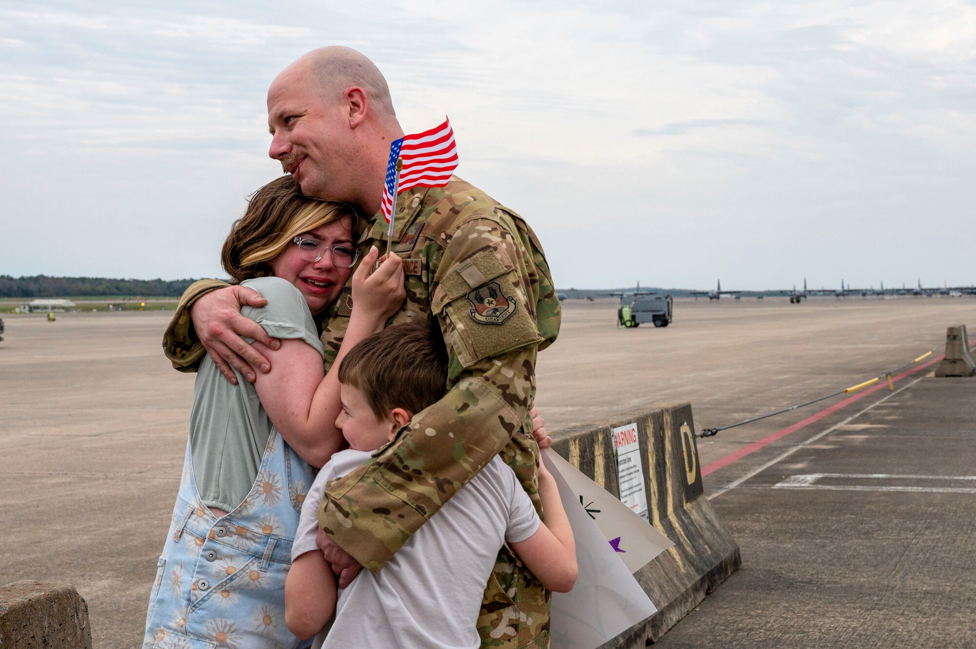 An Airman from the 19th Airlift Wing reunites with his family at Little Rock Air Force Base, Arkansas, after returning from a deployment