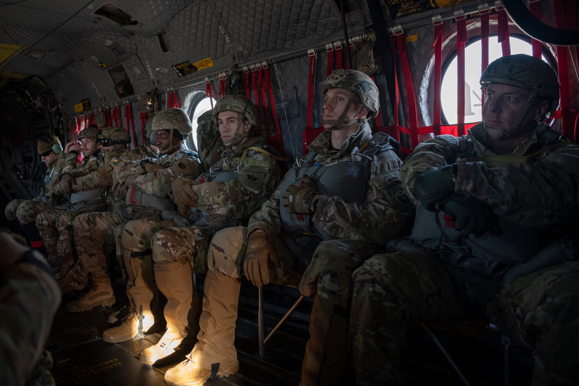 A photo of soldiers and airmen riding on a helicopter