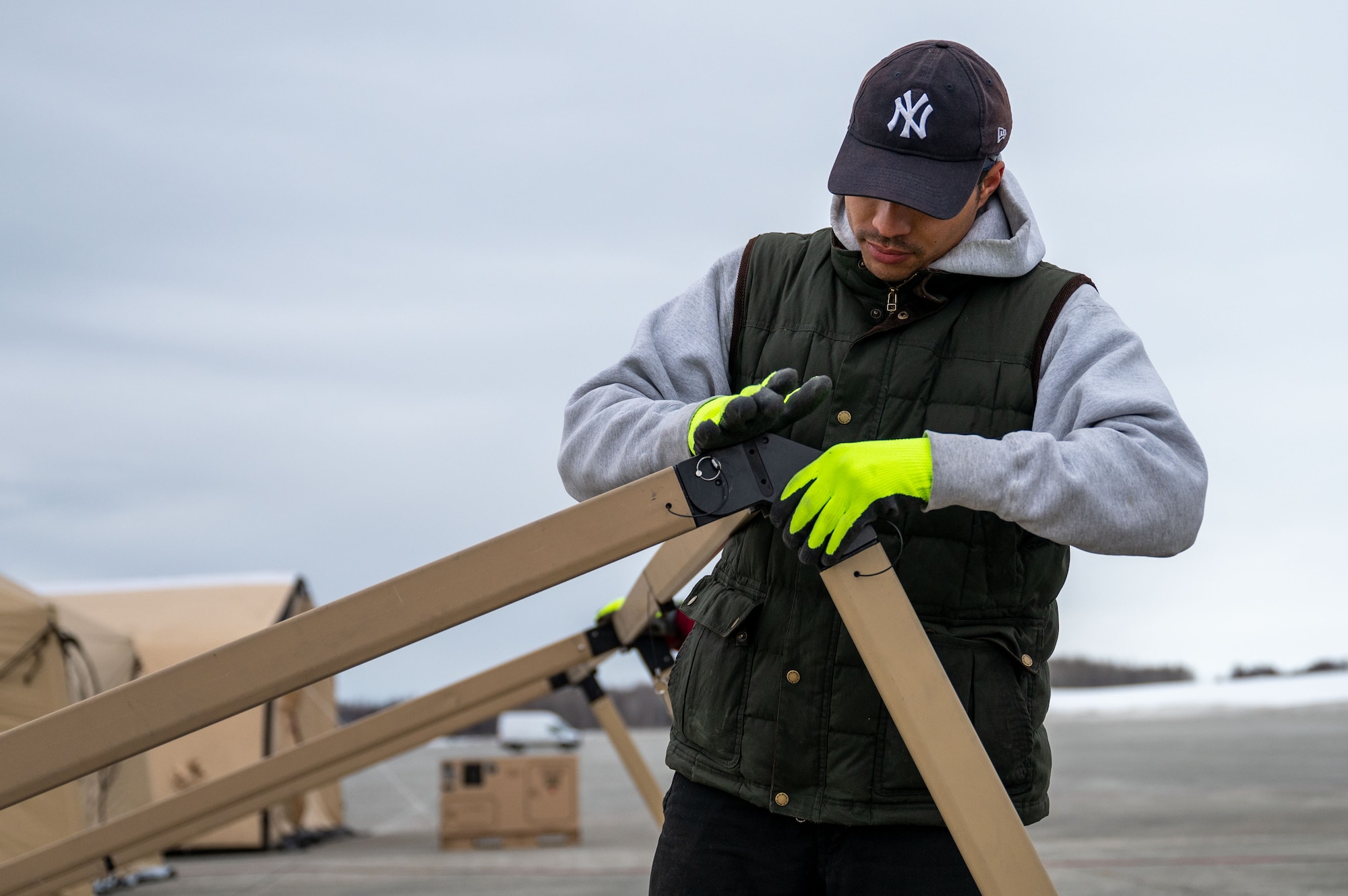 A picture of a person assembling a stand for solar panels