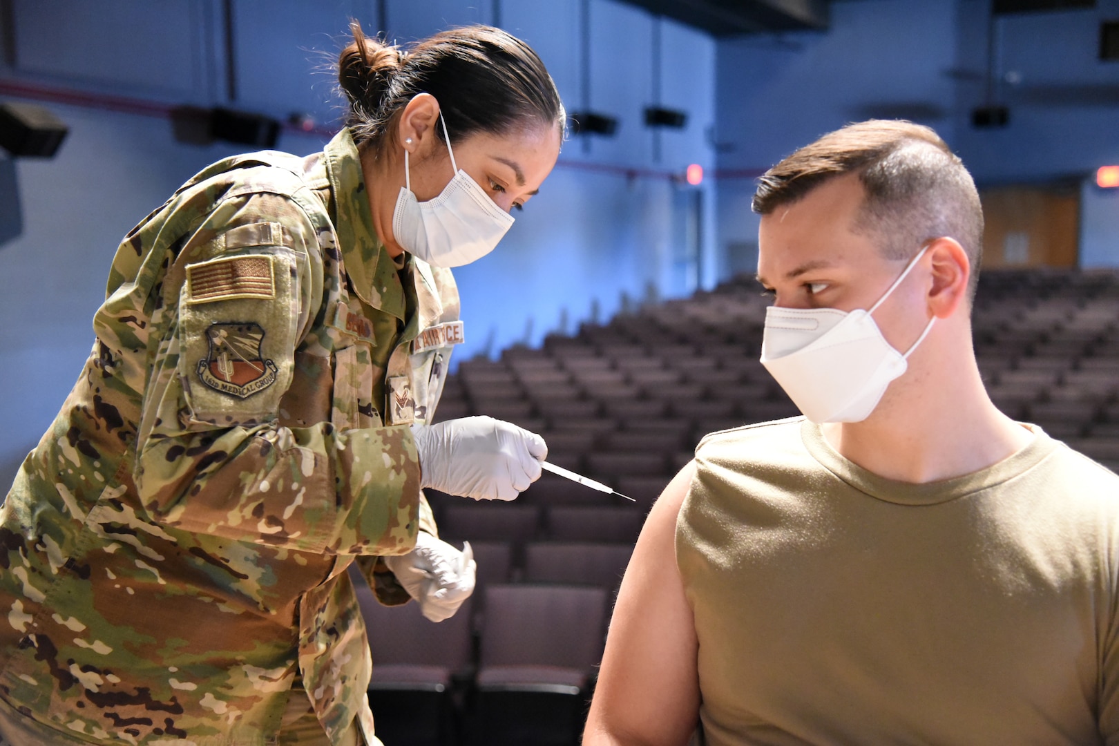 Senior Airman Carmen Gerda, 162nd Medical Squadron, aerospace medical technician, administers the COVID-19 vaccine to a service member at Davis-Monthan Air Force Base, Tucson, Arizona, May 6, 2021.