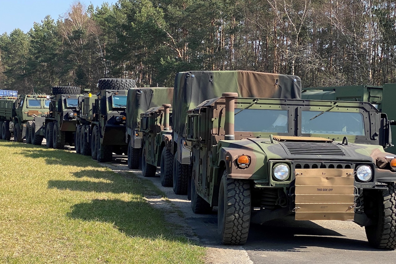 Army vehicles line up.