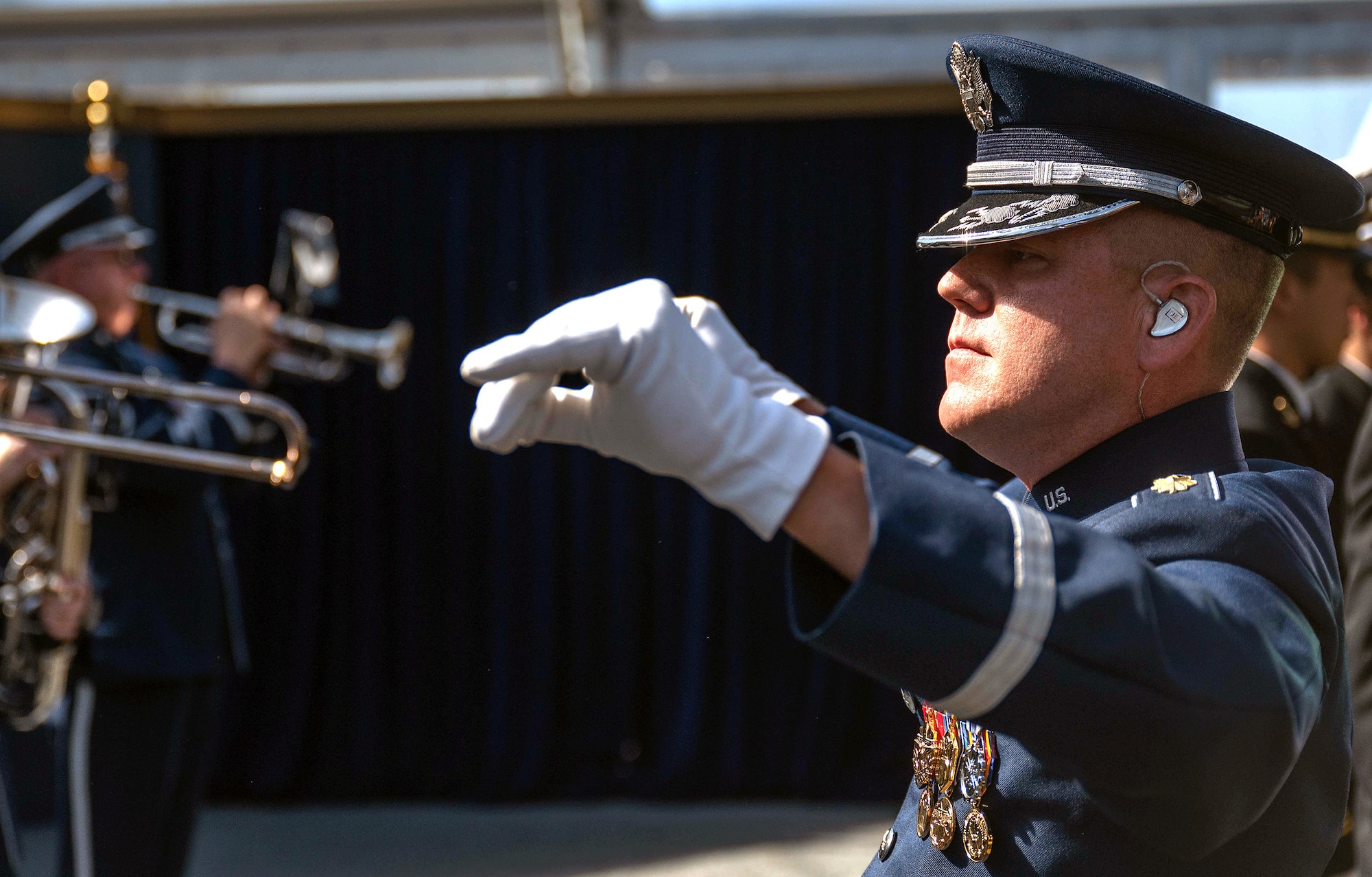Air Force Maj. Dustin M. Doyle, Band of the West commander, conducts band members during the National Medal of Honor Museum ceremony
