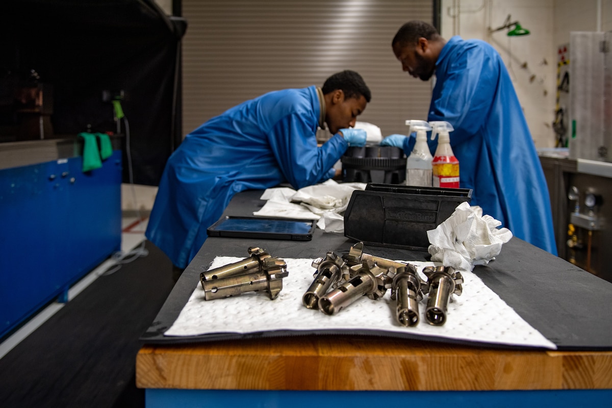 U.S. Air Force Airman Roderick Dennis and Airman 1st Class Jamorris Lewis, both 23rd Maintenance Squadron nondestructive inspection apprentices, inspect an A-10 Thunderbolt II GAU-8 weapons system part at Moody Air Force Base, Georgia, April 5, 2022. An NDI Airman’s job includes hyper-detailed inspections using those tools to ensure component integrity, which keeps three vastly different aircraft mission ready. (U.S. Air Force photo by Staff Sgt. Melanie A. Bulow-Gonterman)