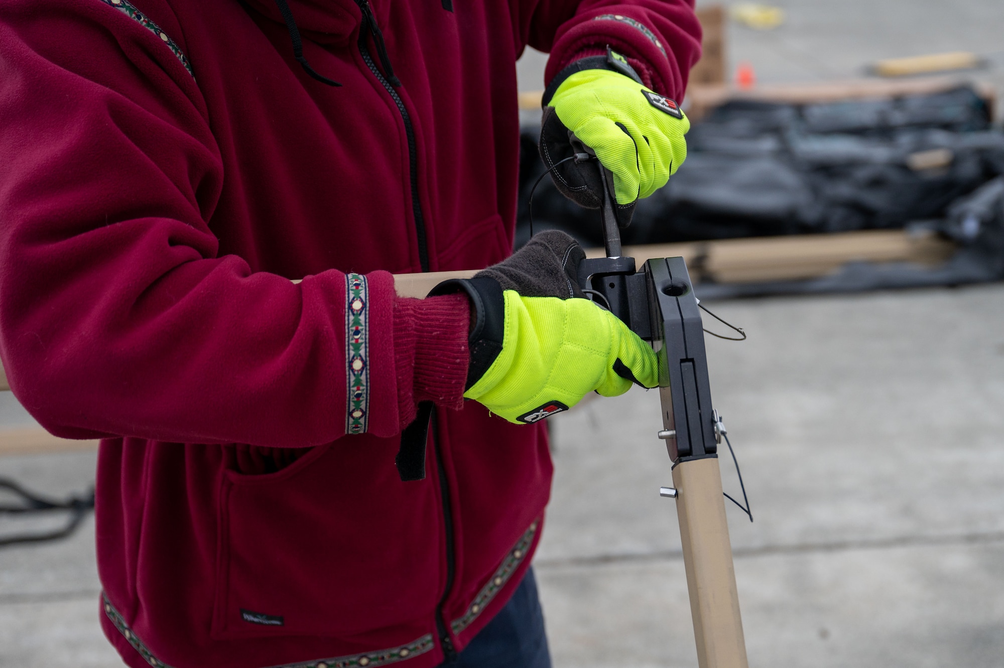 A photo of a person's hands assembling a stand for solar panels