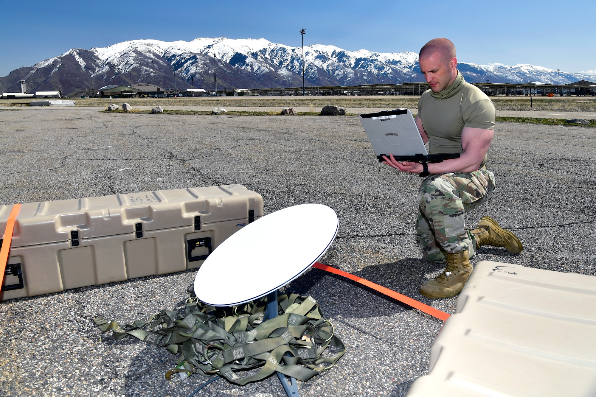 Master Sgt. Caleb Frisbie, 242nd Combat Communications Squadron, sets up and tests communication equipment