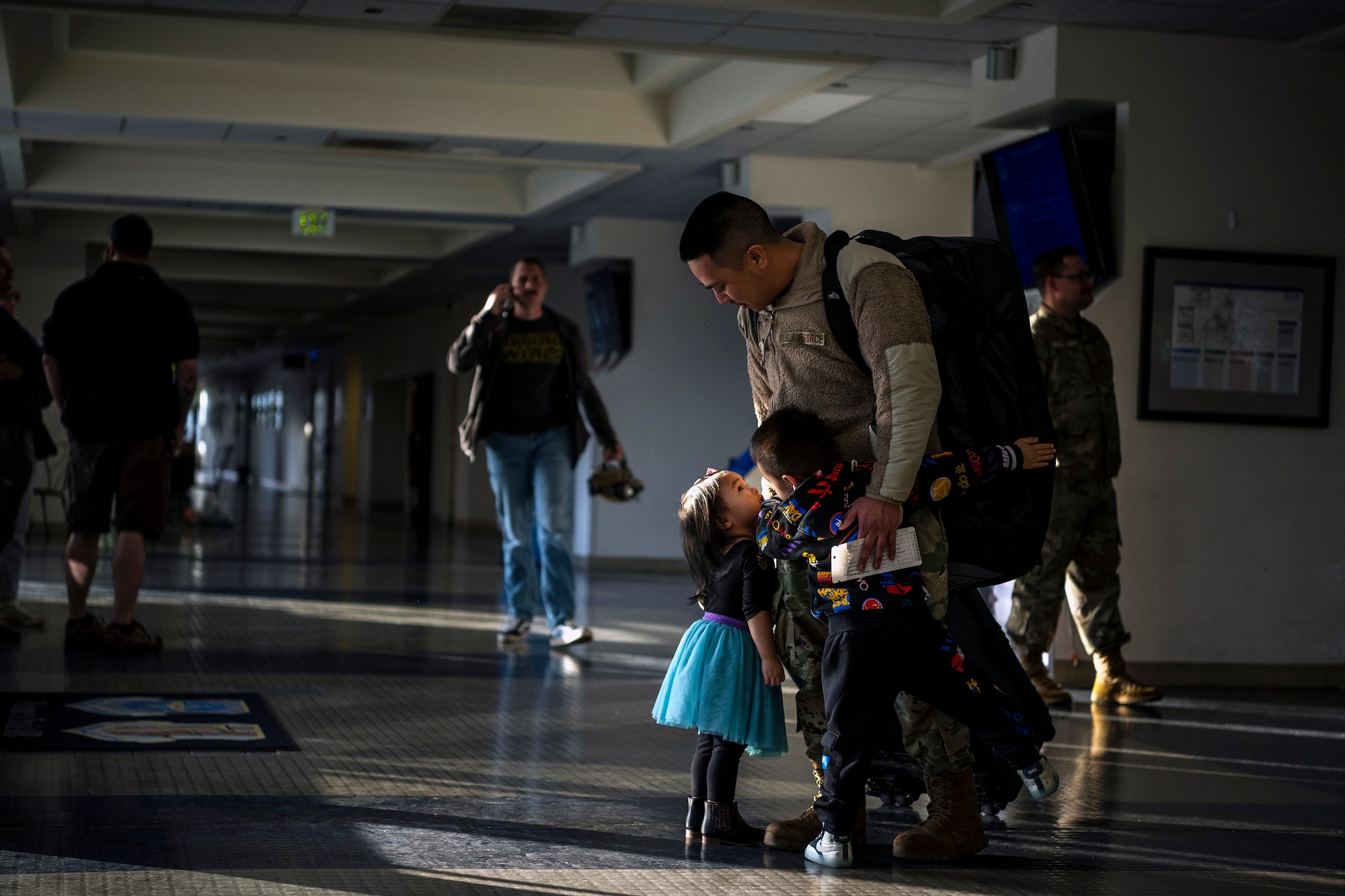 Staff Sgt. Jonathan Agudo, 821st Contingency Response Support Squadron noncommissioned officer in charge of wing communication security, says goodbye to his children