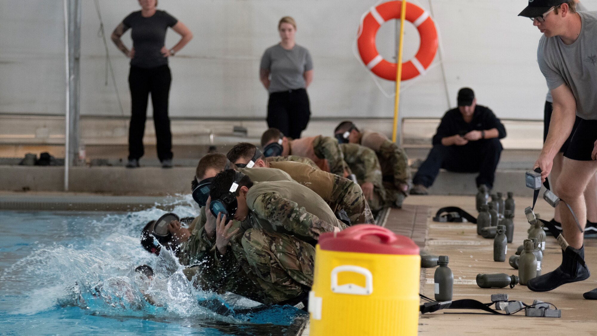 Air Force Special Warfare candidates begin a pool evolution during Assessment and Selection at Chaparral Pool on Joint Base Lackland-San Antonio, Texas, Mar. 15, 2022. One third of graduates from the Special Warfare Training Wing pipelines will feed directly into operational AFSOC units, to include Combat Controllers, Special Reconnaissance Airmen, Special Tactics Officers, and some Pararescuemen.