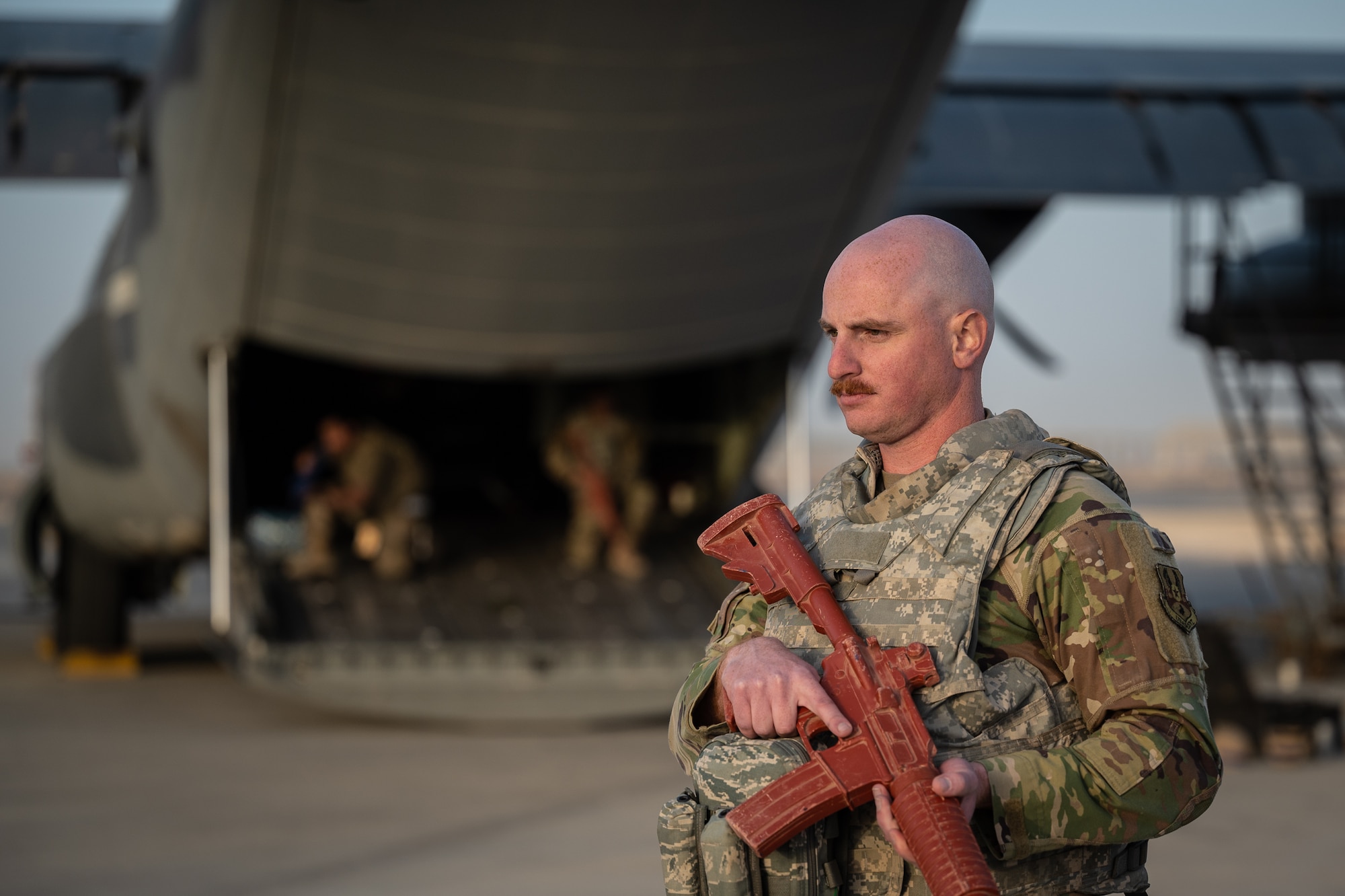 Staff Sgt. Matthew Hassey, 801st Expeditionary Maintenance Squadron electrical and environmental systems journeyman, performs perimeter security around an HC-130J Combat King II aircraft during airfield security operations training led by the 332d Expeditionary Security Forces Squadron at an undisclosed location in Southwest Asia, April 5, 2022. Each trainee learned about perimeter security as well as defensive positions aboard the aircraft. (U.S. Air Force photo by Master Sgt. Christopher Parr)