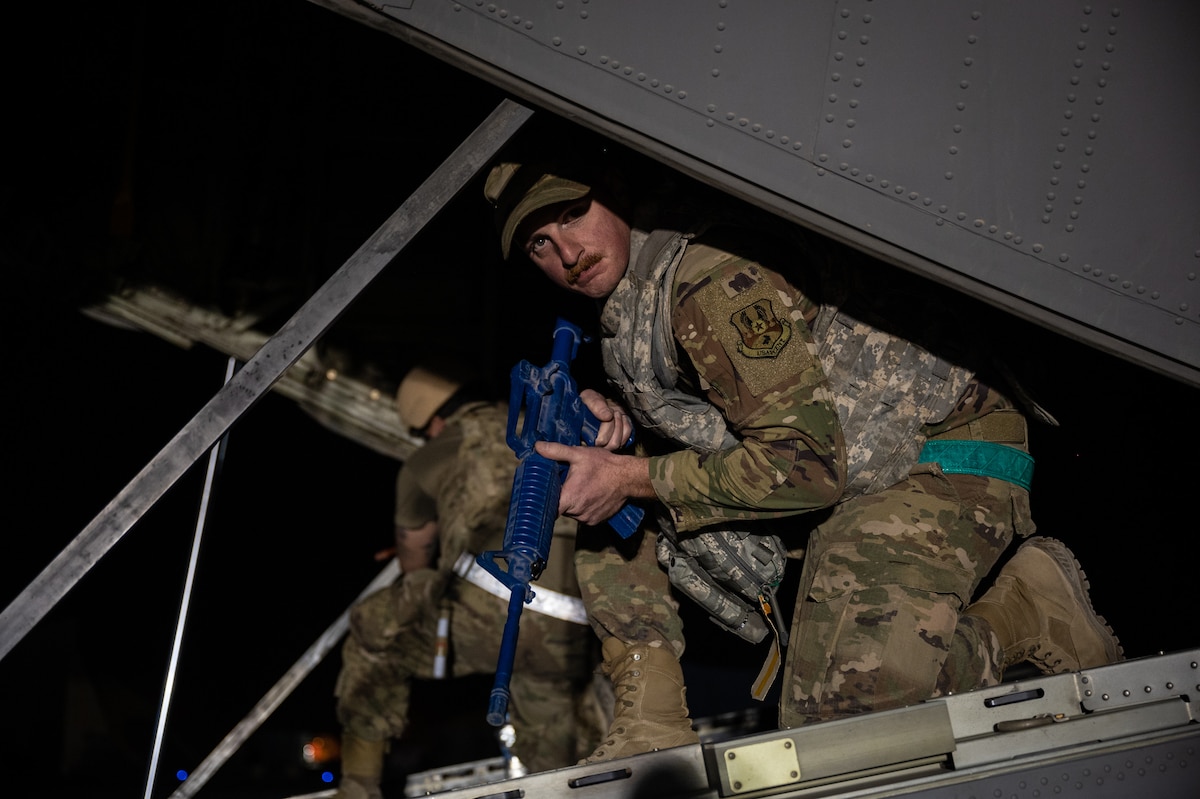 Staff Sgt. Matthew Hassey, 801st Expeditionary Maintenance Squadron electrical and environmental systems journeyman takes up a defensive position aboard an HC-130J Combat King II aircraft during airfield security operations training led by the 332d Expeditionary Security Forces Squadron at an undisclosed location in Southwest Asia, April 5, 2022. The training focused on small team perimeter security, personnel placement for aircraft defense, and basic defense postures. (U.S. Air Force photo by Master Sgt. Christopher Parr)