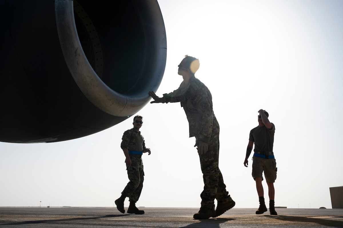 U.S. Air Force 1st Lt. David Bernal Del Agua, center, a pilot assigned to the 50th Expeditionary Air Refueling Squadron, conducts preflight checks