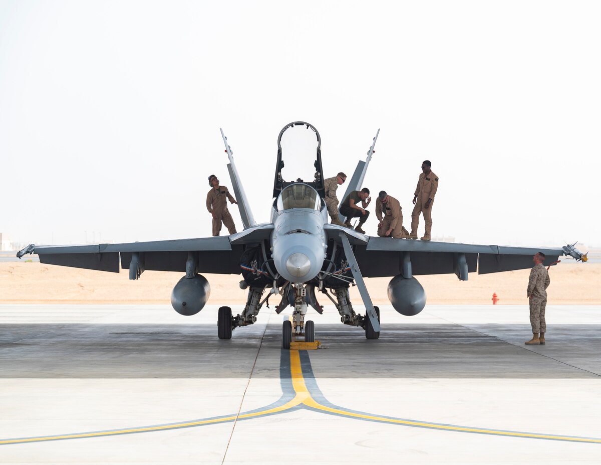 U.S. Aircraft Maintenance Marines assigned to the Marine Fighter Attack Squadron 115, preform post-flight maintenance checklists