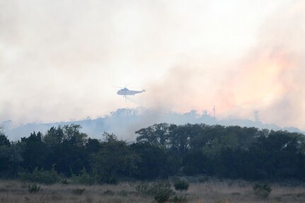 Helicopter flying over fire.