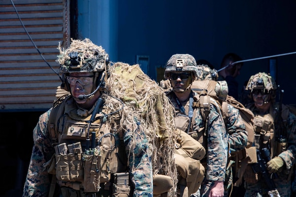 U.S. Marines with 1st Battalion, 3rd Marines, 3rd Marine Division prepare to board a CH-53E Super Stallion helicopter assigned to Marine Heavy Helicopter Squadron 466 (HMH-466) on the flight deck of the forward-deployed amphibious dock landing ship USS Ashland (LSD 48) during Balikatan 22, off the coast of the Philippines, March 28, 2022. Balikatan is an annual exercise between the Armed Forces of the Philippines and U.S. military designed to strengthen bilateral interoperability, capabilities, trust, and cooperation built over decades shared experiences. Balikatan, Tagalog for 'shoulder-to-shoulder,' is a longstanding bilateral exercise between the Philippines and the United States highlighting the deep-rooted partnership between both countries. Balikatan 22 is the 37th iteration of the exercise and coincides with the 75th anniversary of U.S.-Philippine security cooperation.