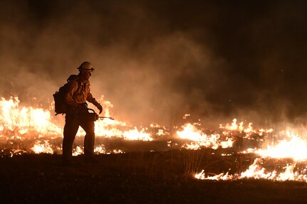 One firefighter dropping flames to stop wildfire.
