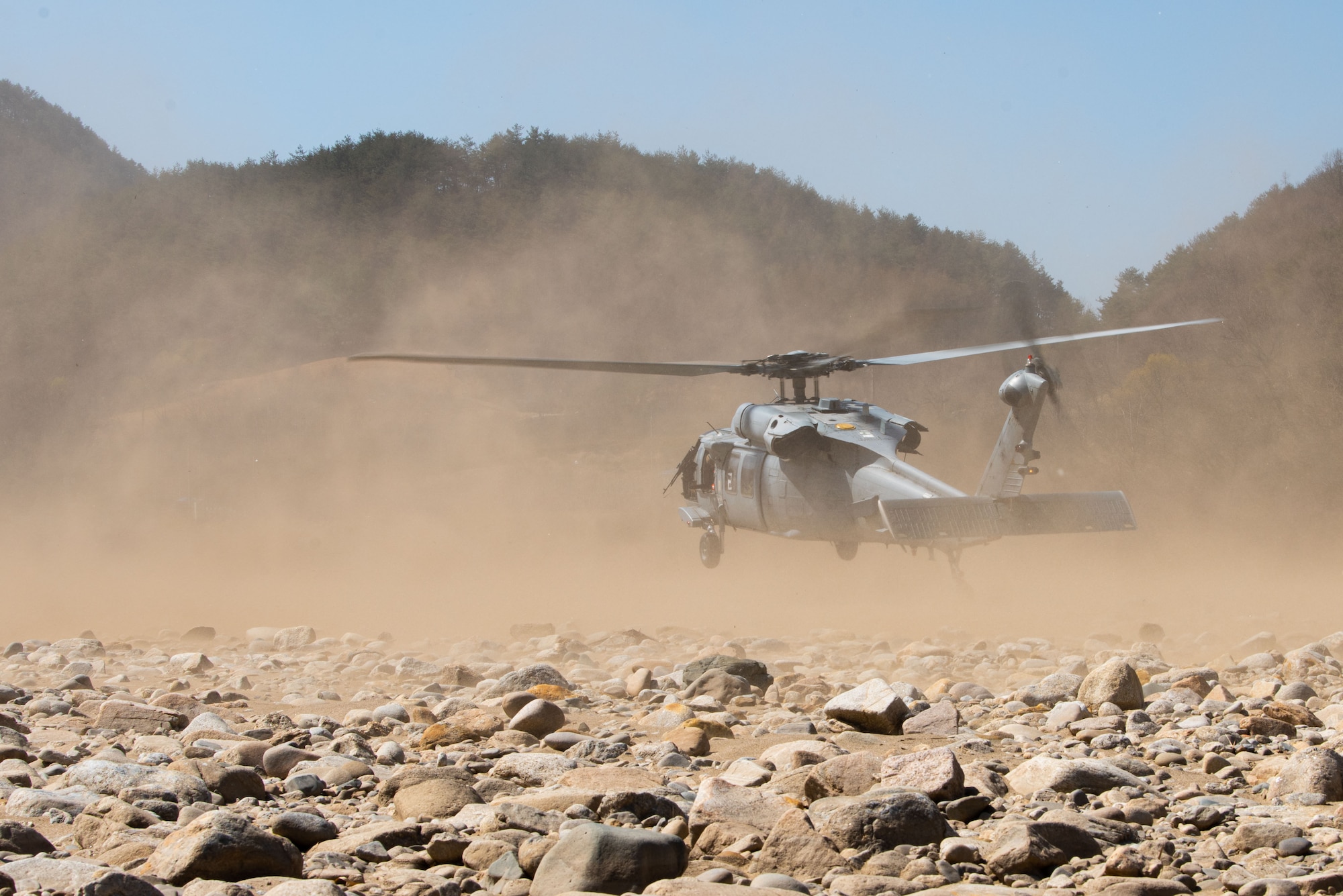 Tech. Sgt. Zach Yoakam, 8th Operations Support Squadron survival, evasion, resistance and escape flight chief, communicates with aircraft through a PRA MH-60S Seahawk prepares for takeoff during a during a Combat Search and Rescue Training Event April 8, 2022. More than 200 joint personnel and 27 participating squadrons from across the Pacific participated in CSARTE 22-2. The goals for CSARTE is to create realistic combat search and rescue training with both joint and combined forces. The scenarios include preplanned and immediate survivor pickup locations that require detailed integration of assets and planning in order to execute a safe recovery of a simulated downed aircraft. (U.S. Air Force photo by Senior Airman Megan Estrada)C-152 to initiate recovery operations during a Combat Search and Rescue Training Event April 8, 2022. More than 200 joint personnel and 27 participating squadrons from across the Pacific participated in CSARTE 22-2. The goals for CSARTE is to create realistic combat search and rescue training with both joint and combined forces. The scenarios include preplanned and immediate survivor pickup locations that require detailed integration of assets and planning in order to execute a safe recovery of a simulated downed aircraft.