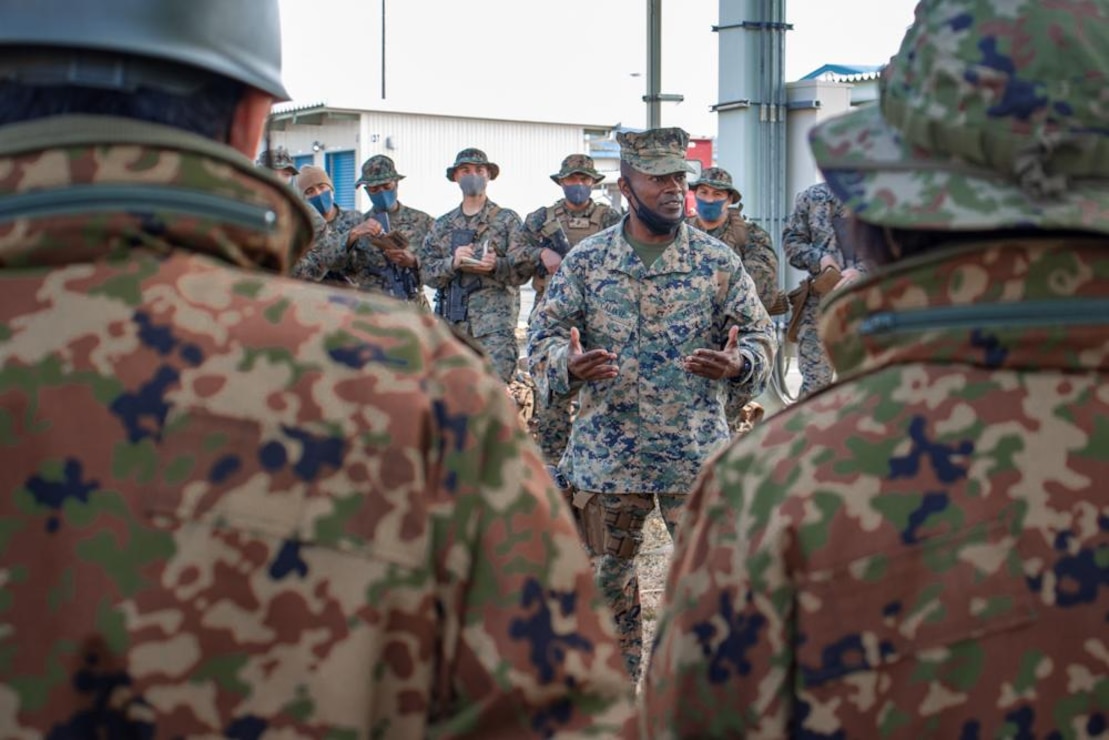 U.S. Marine Corps Lt. Col. Stanley Calixte, commanding officer of Combat Logistics Battalion 31 (CLB), 31st Marine Expeditionary Unit, briefs Japanese soldiers with the 1st Amphibious Rapid Deployment Regiment before a convoy for a company-level training exercise on Combined Arms Training Center Camp Fuji, Shizuoka Prefecture, Japan, Mar. 17, 2022.