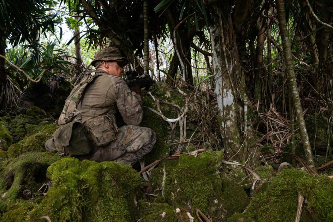 A British Royal Marine Commando with 40 Commando Royal Marines, sets security during an experimental jungle training exercise, Naval Base Guam, Guam, Mar. 22, 2022. Exercise Noble Arashi is part of 31st MEU’s Noble Series of exercises which are used to validate or invalidate the Family of Naval Concepts, develop techniques and procedures for the employment of MEU assets in support of sea denial and fleet maneuver, and inform future force design and experimentation efforts. The 31st MEU is operating aboard ships of the America Strike Group in the 7th fleet area of operations to enhance interoperability with allies and partners, and serve as a ready response force to defend peace and stability in the Indo-Pacific region. (U.S. Marine Corps photos by Lance Cpl. Yvonne Iwae)