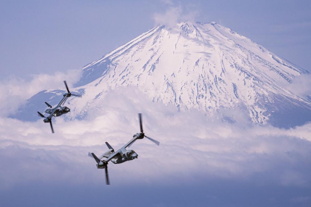 A U.S. Marine Corps MV-22B Osprey with Marine Medium Tiltrotor Squadron 265 (Reinforced), 31st Marine Expeditionary Unit, and a Japanese Ground Self-Defense Force V-22 Osprey with the 107th Aviation Unit conduct a bilateral formation flight over Mount Fuji, Japan, Mar. 17, 2022. Bilateral flights build familiarity and interoperability between U.S. and Japanese aviation units. Maritime Defense Exercise Amphibious Ready Deployment Brigade is a bilateral exercise meant to increase interoperability and strengthen ties between U.S. and Japanese forces for the defense of Japan. (U.S. Marine Corps photo by Lance Cpl. Cesar Ronaldo Alarcon)